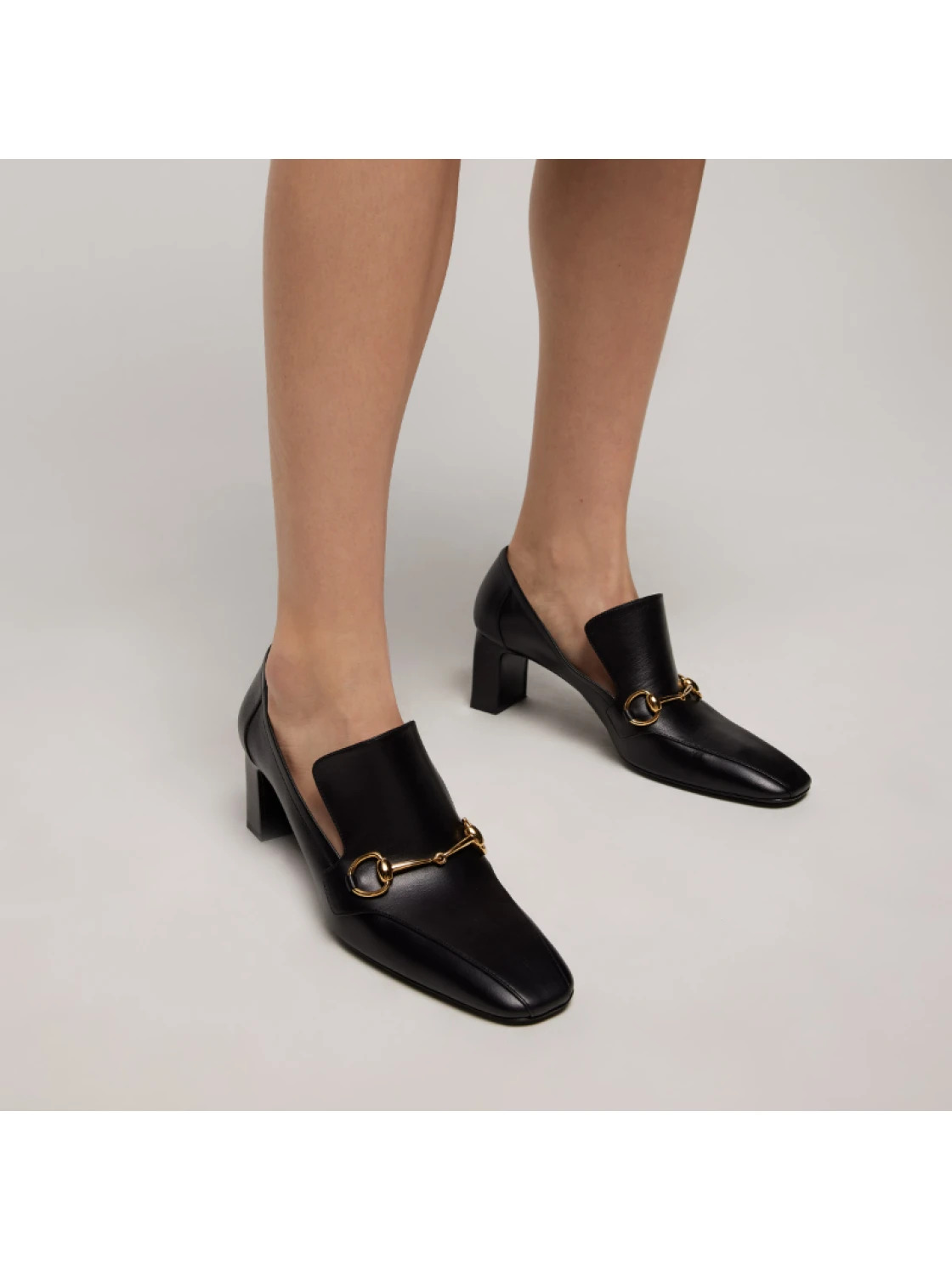 An image of a model wearing Gucci Galleria loafers