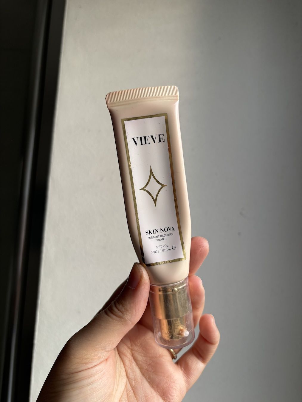 Mica Ricketts holding Vieve Skin Nova Instant Radiance Primer