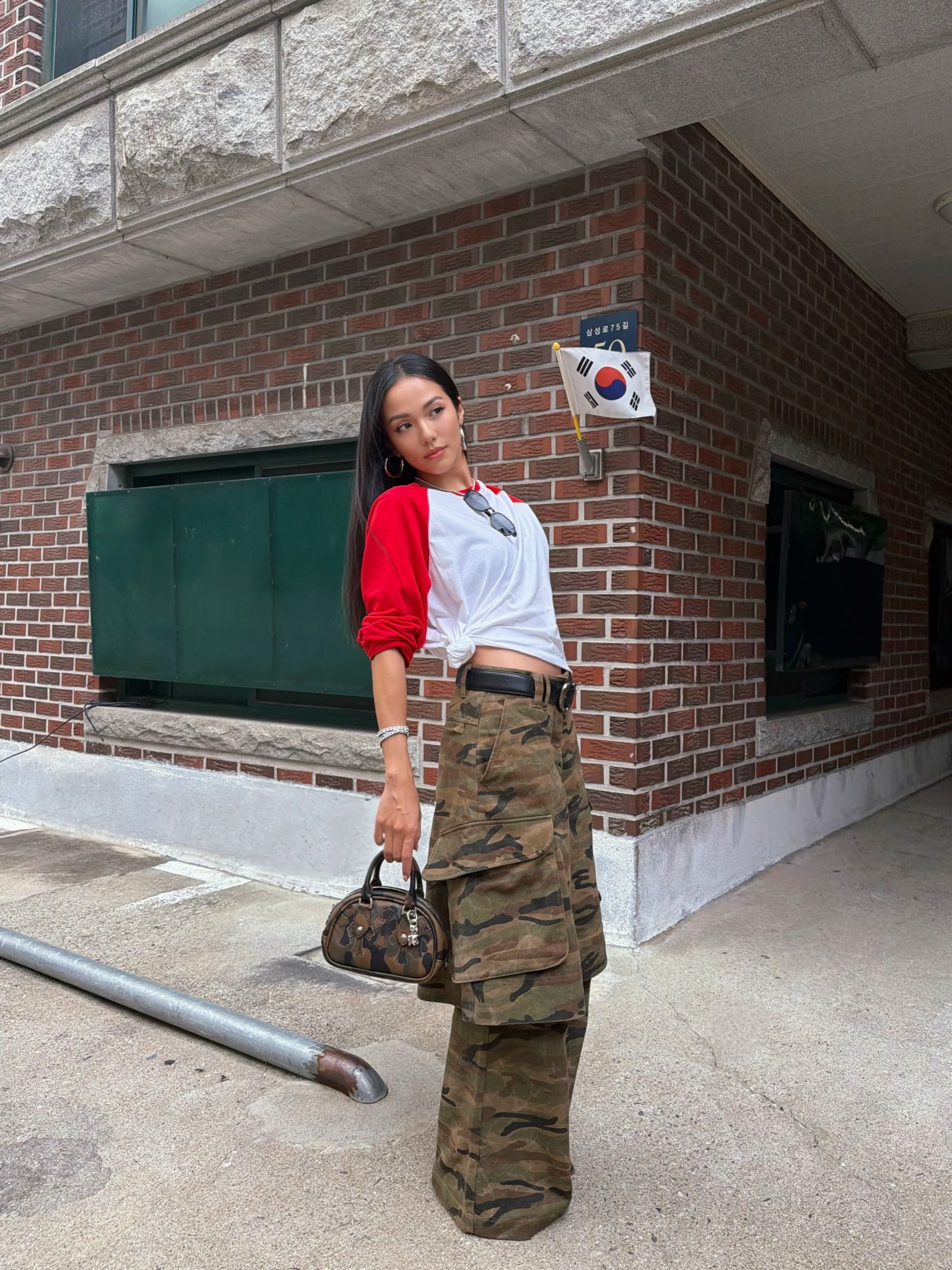 A woman wearing a camo-pant outfit in 2026.