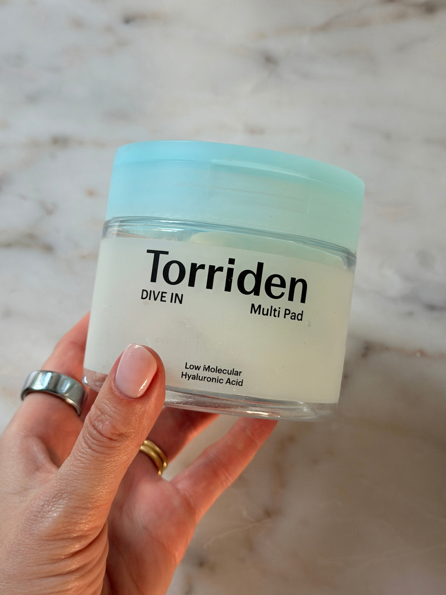 Freelance beauty editor Grace Day holding the Torriden toner pads