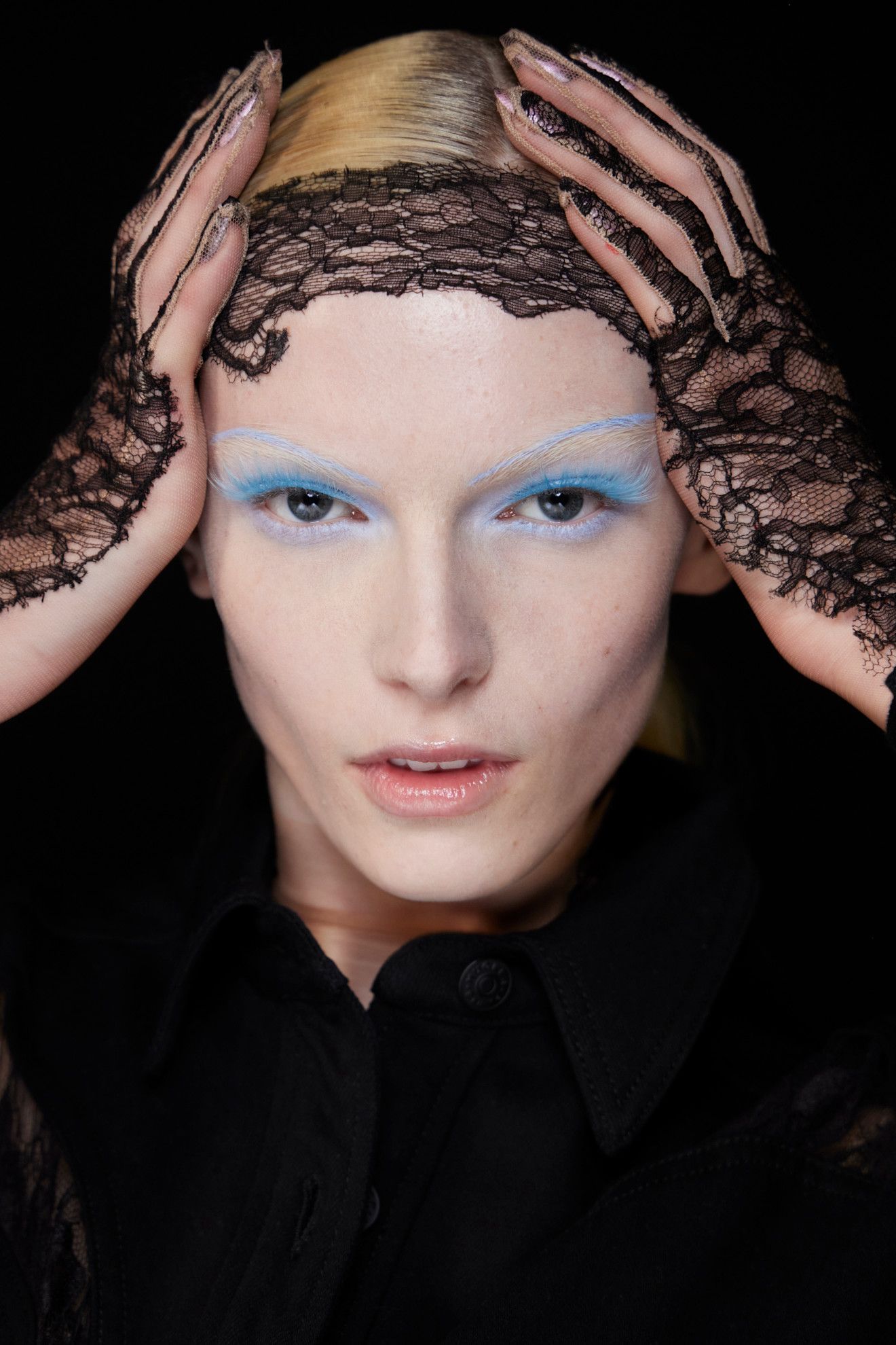 A model wearing light blue lashes.
