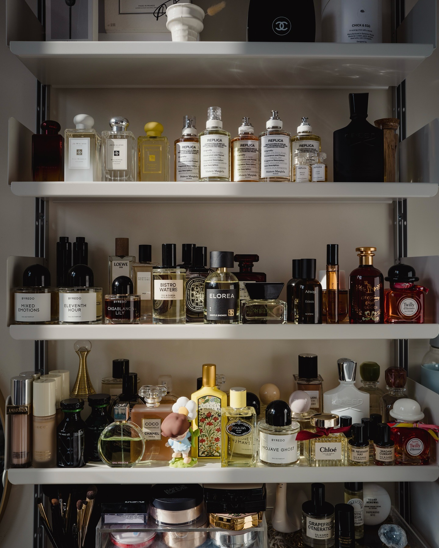 A shelf filled with perfumes