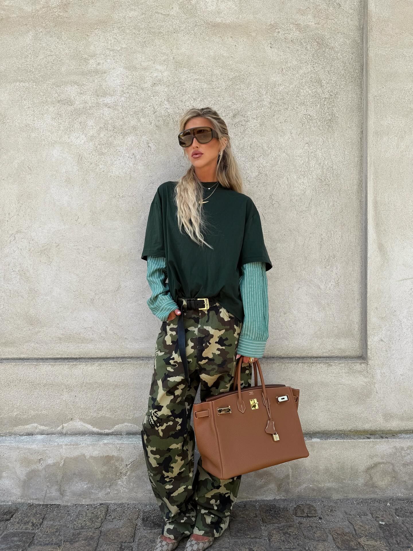An image of a woman wearing best shoes to wear with camo pants fall 2026
