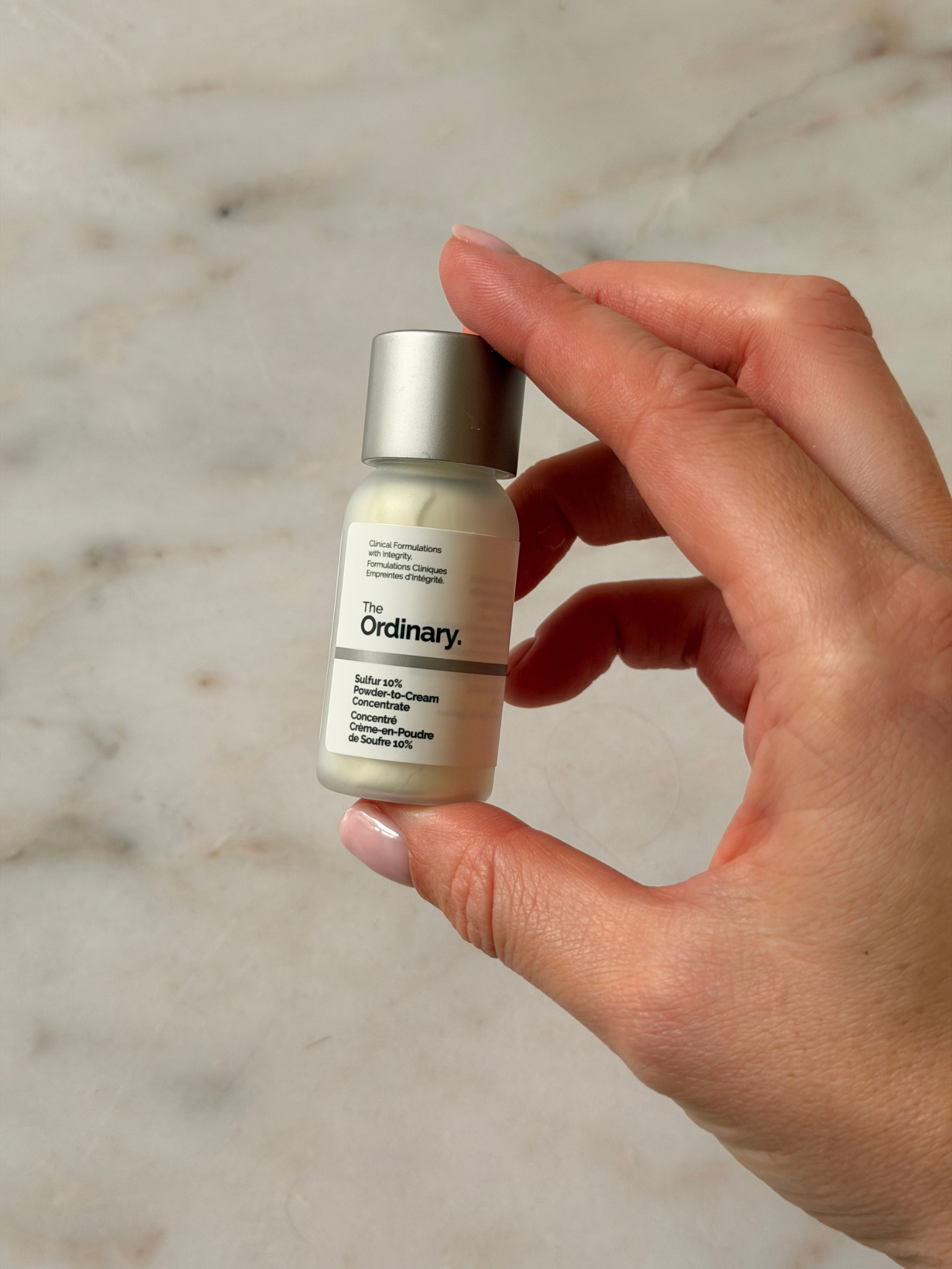 Freelance beauty editor Grace Day holding The Ordinary spot treatment
