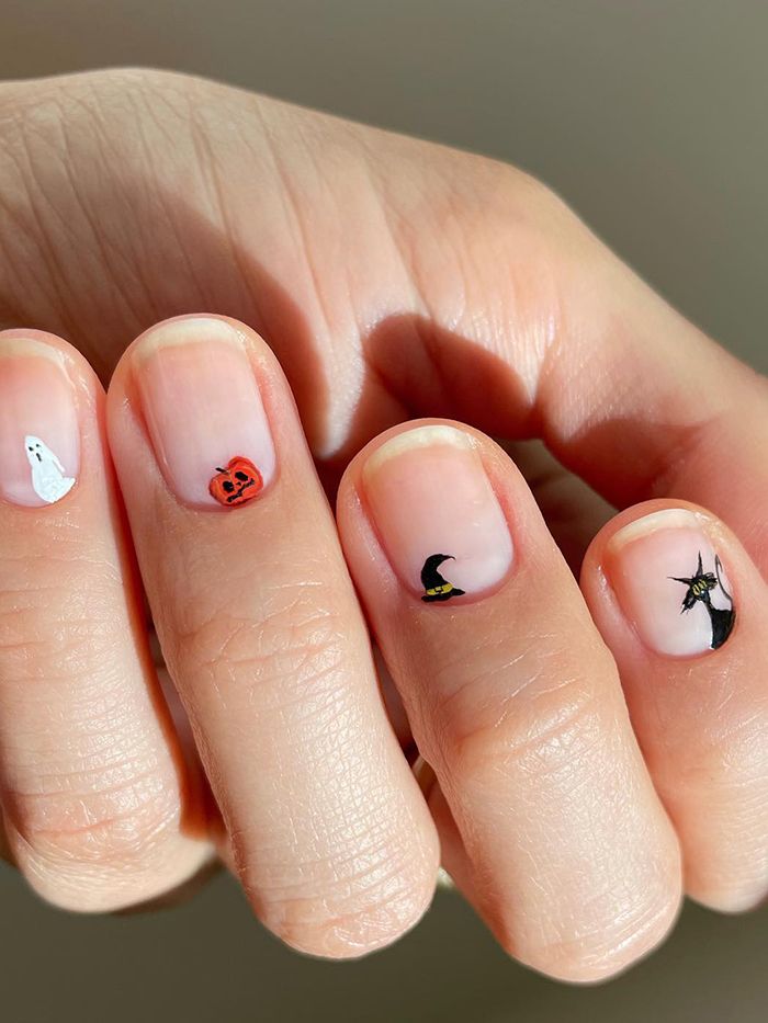 short nails with micro halloween nail art of a ghost, pumpkin, witch and black cat