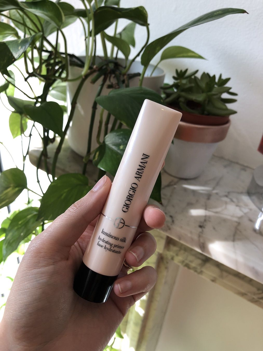 Mica Ricketts holding Armani Luminous Silk Illuminating Primer