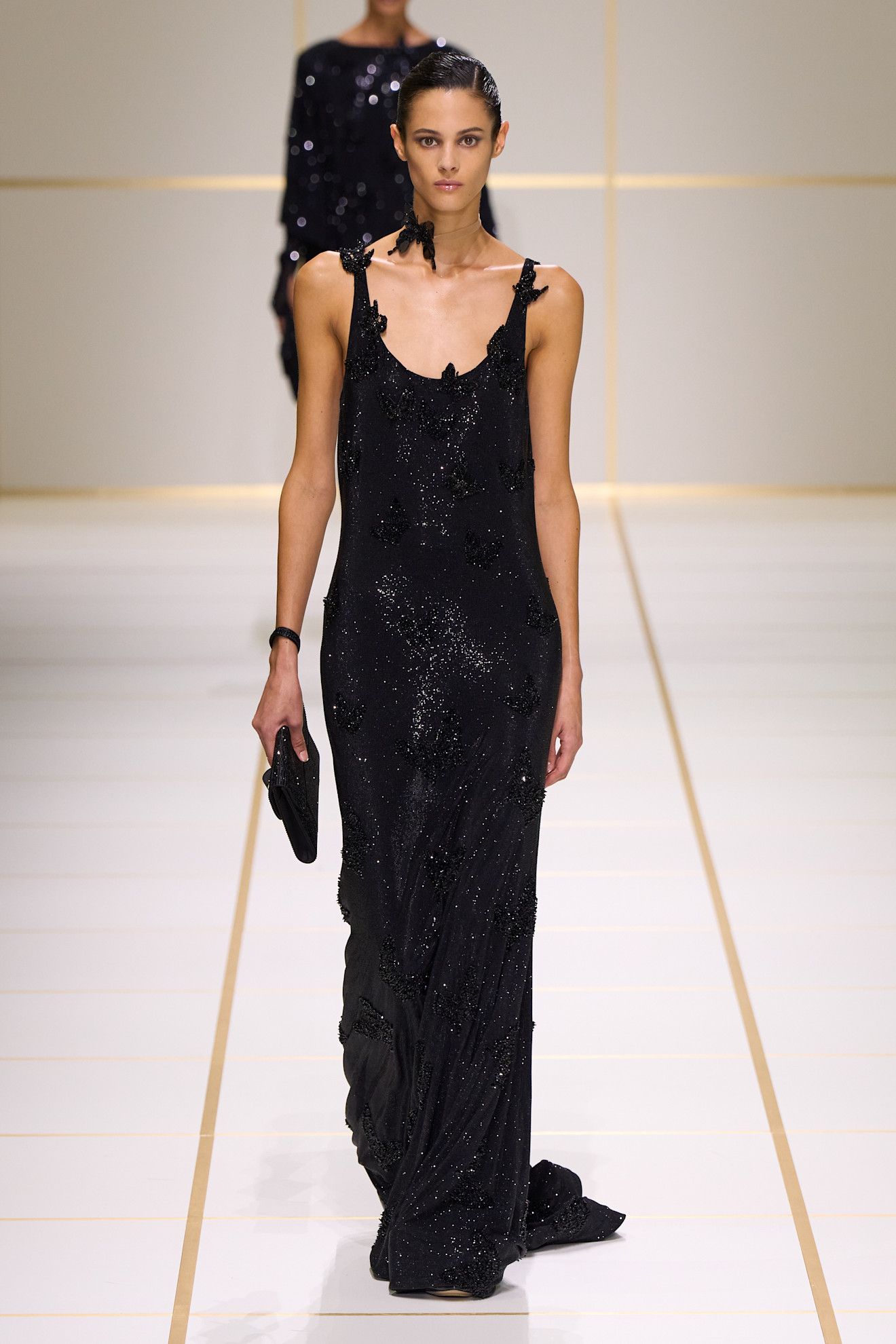 a model walks the giorgio armani s/s 27 runway.