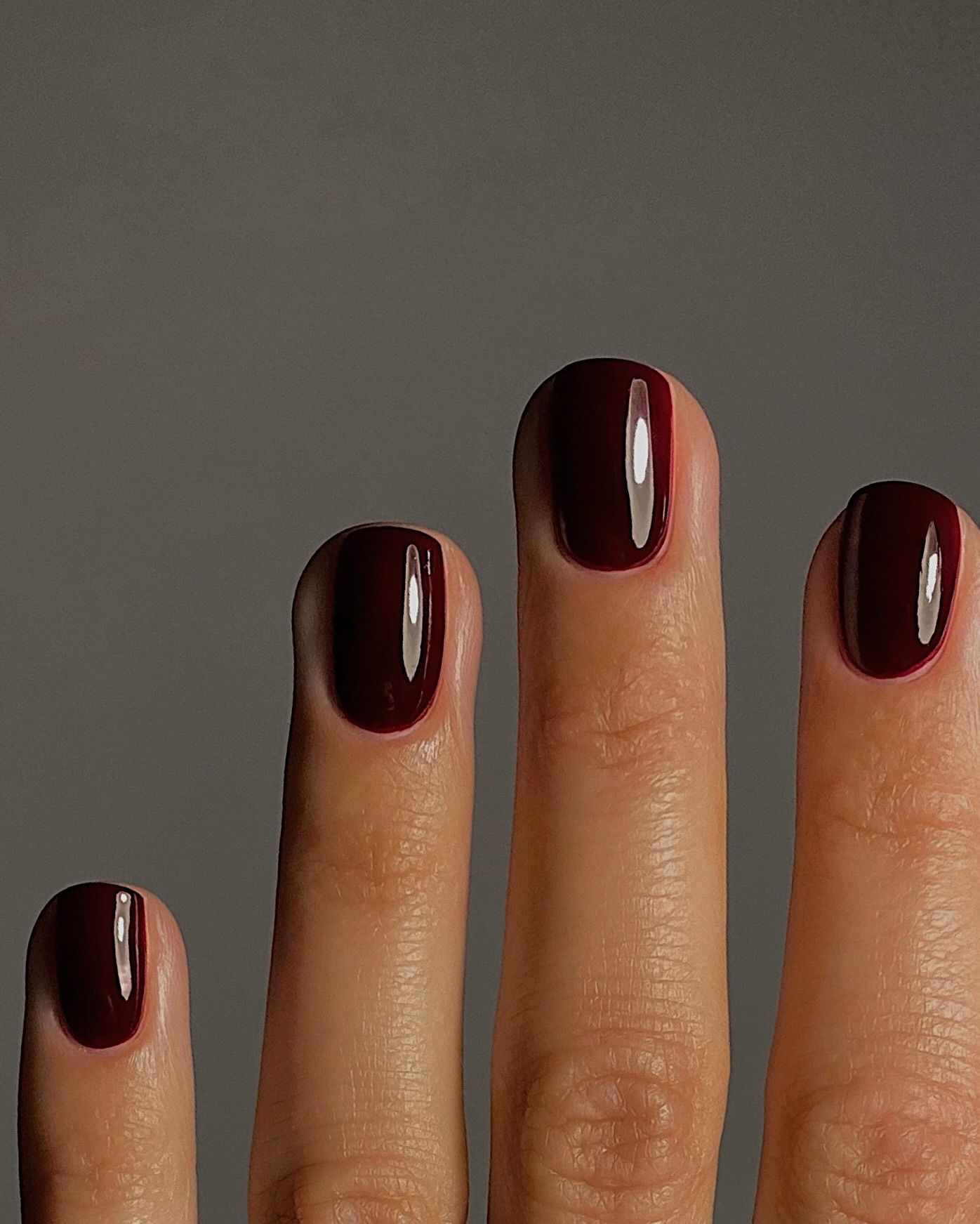 A dark black-red manicure