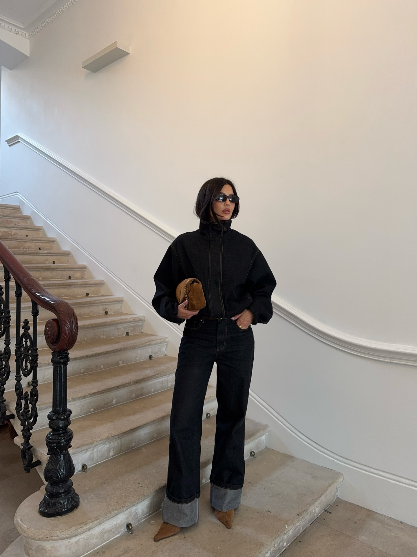 An image of a woman wearing fall boot trend with jeans 2026