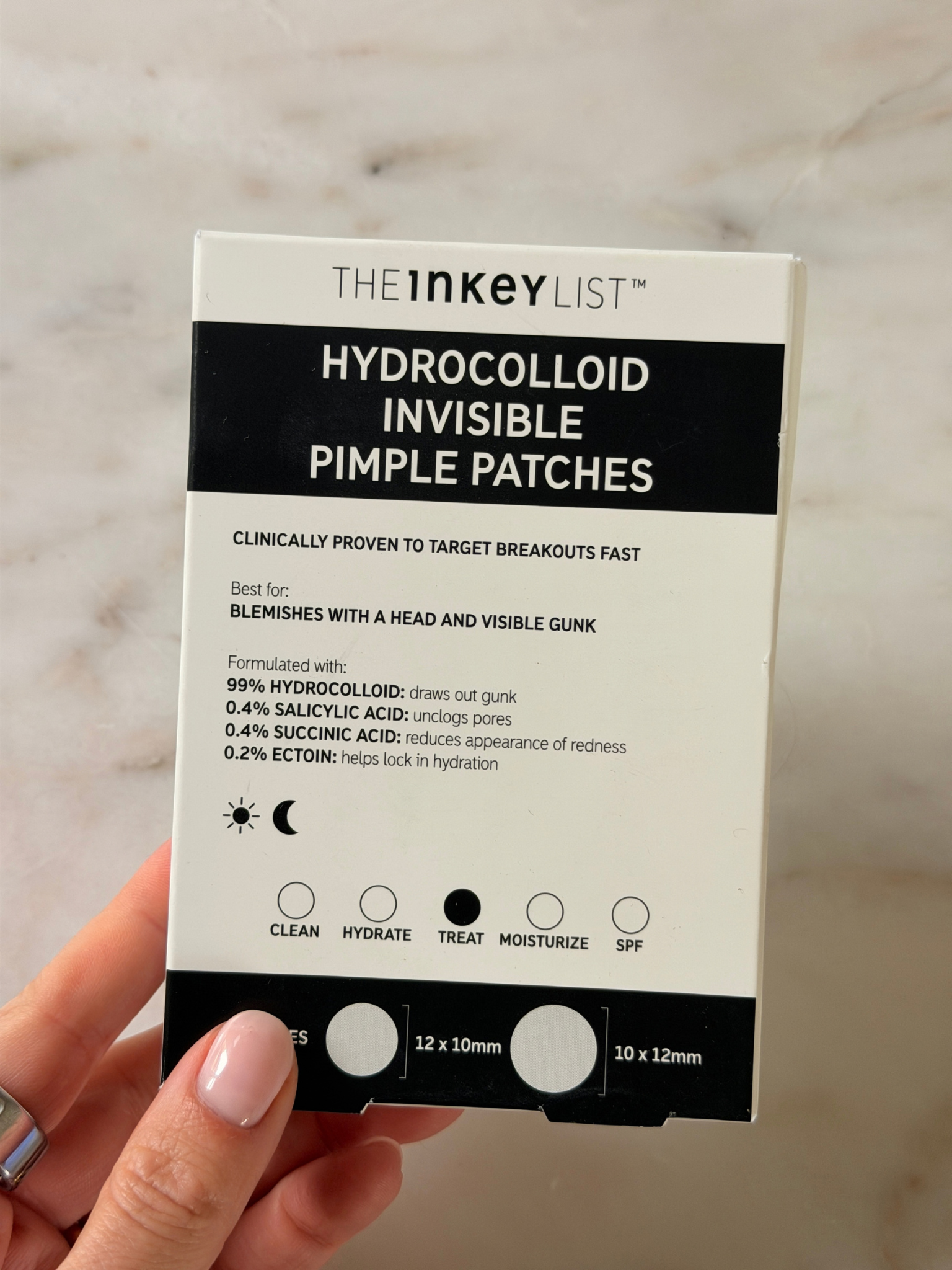 Freelance beauty editor Grace Day holding the Inkey List spot treatment