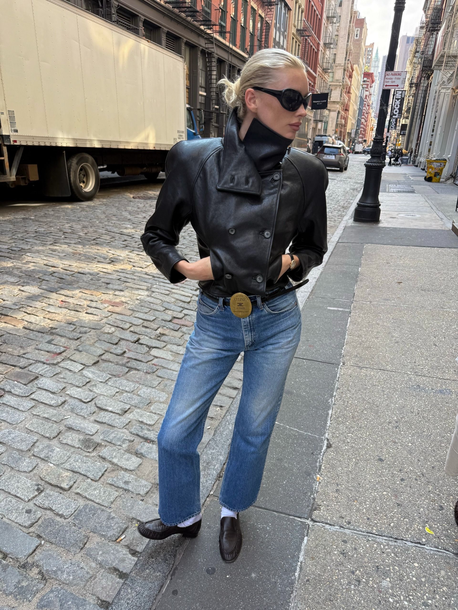 Woman in jeans and a large buckle belt