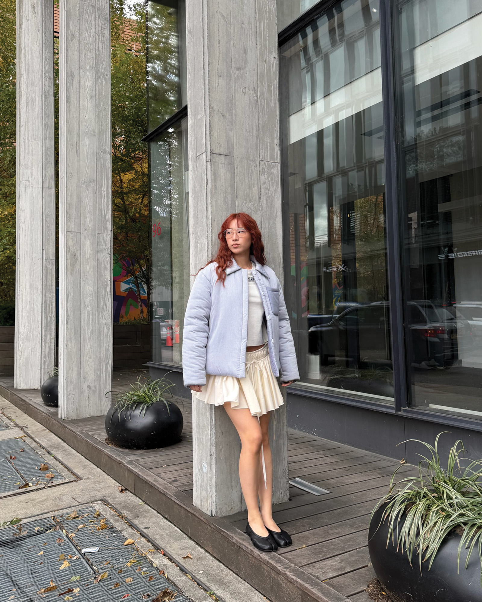 Who What Wear Editor in Residence Kristina Ang wearing a cropped coat with a miniskirt and ballet flats.