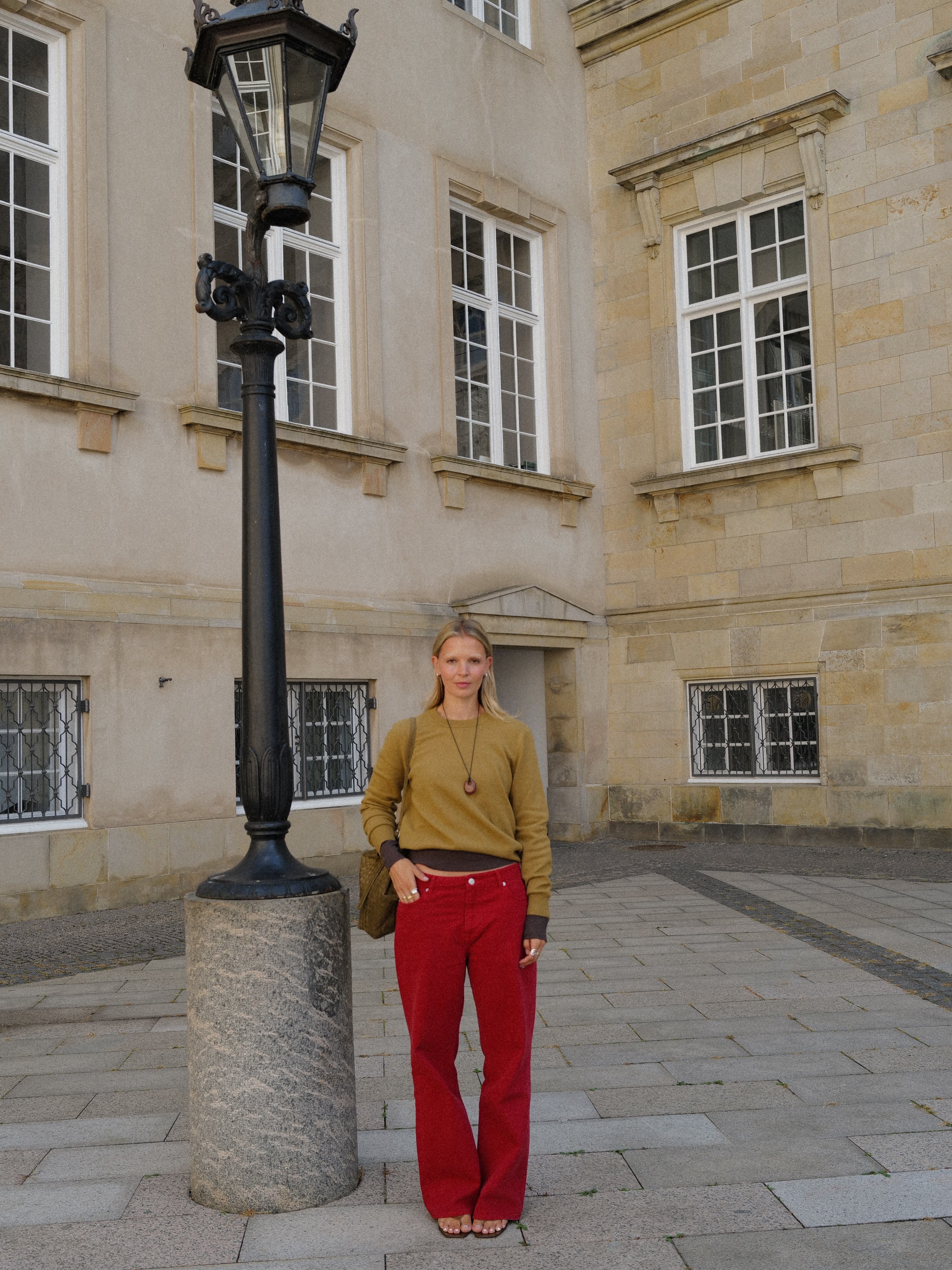 Influencer Hollie Mercedes wearing red trousers.