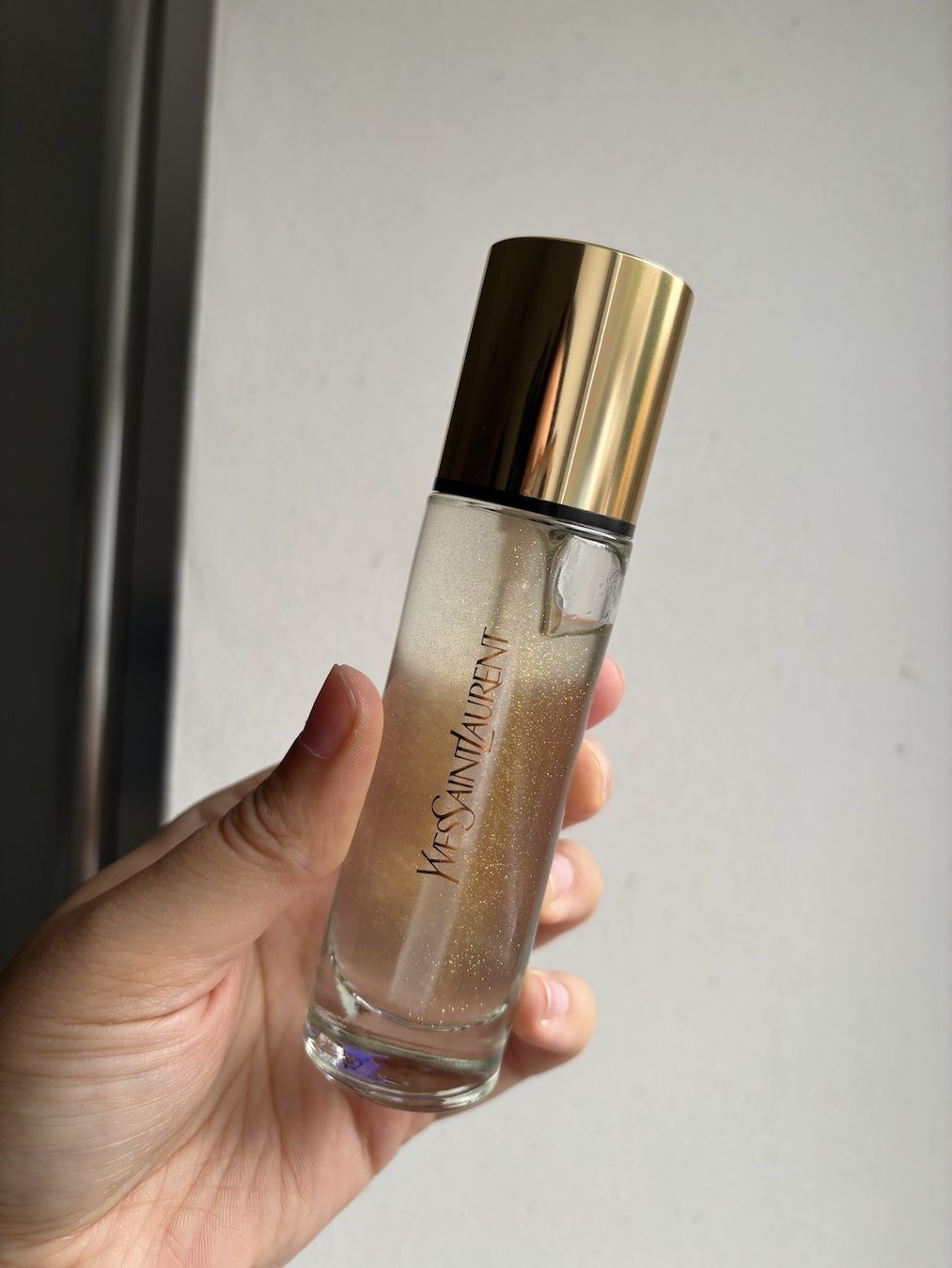 Mica Ricketts holding YSL Touche &Eacute;clat Blur Primer