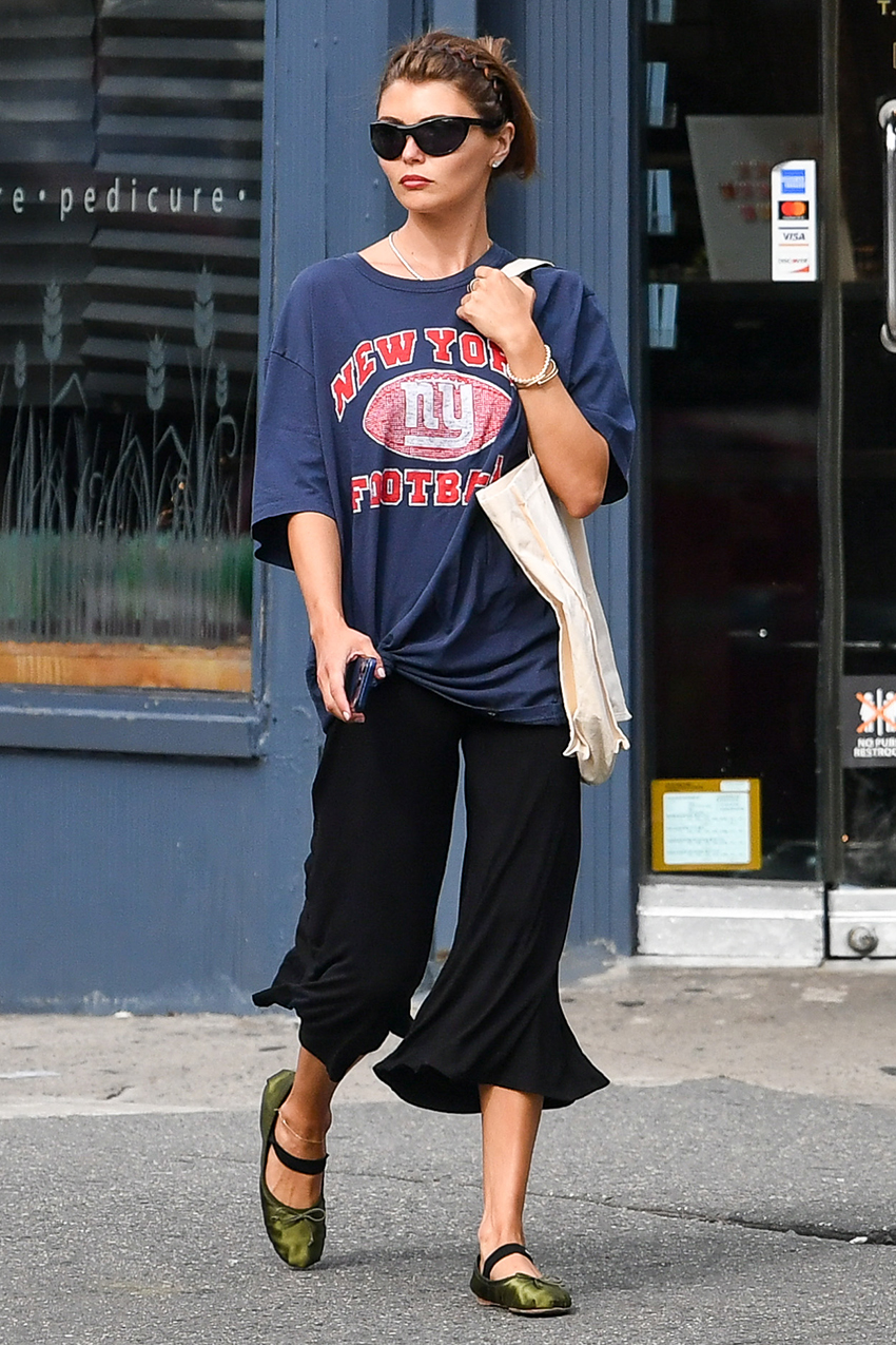 Olivia Jade wearing a graphic tee with cropped black pants and olive green Miu Miu satin ballet flats in NYC
