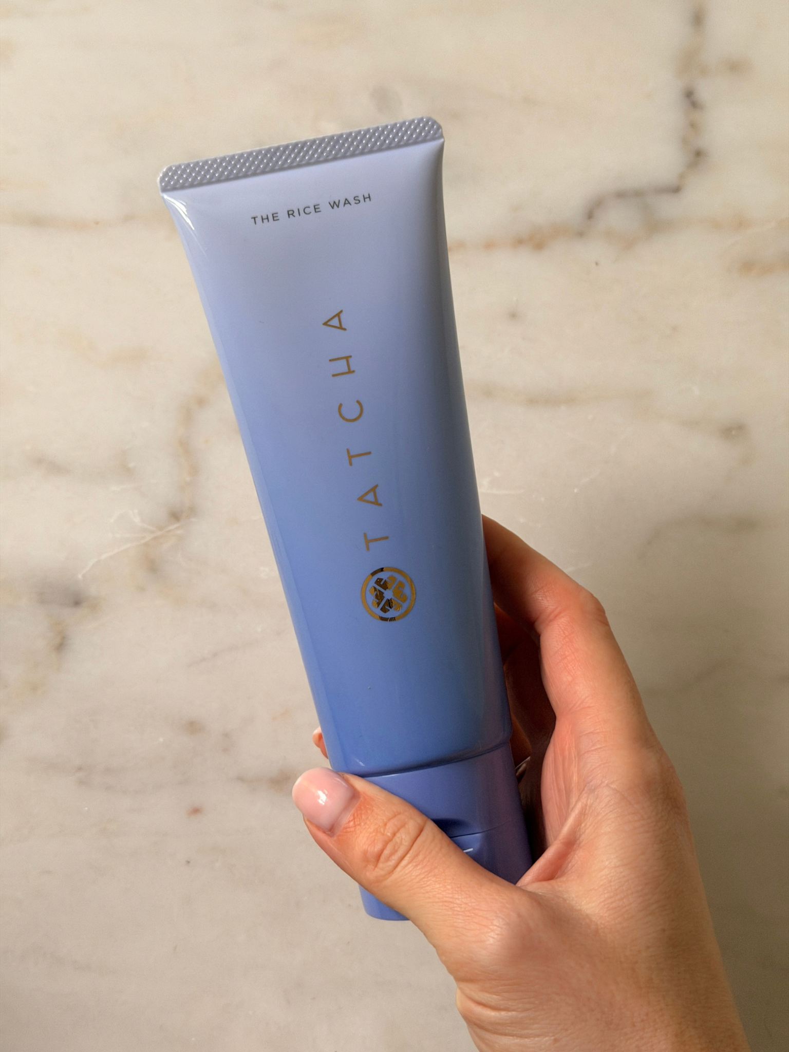 Freelance beauty editor Grace Day holding a tube of