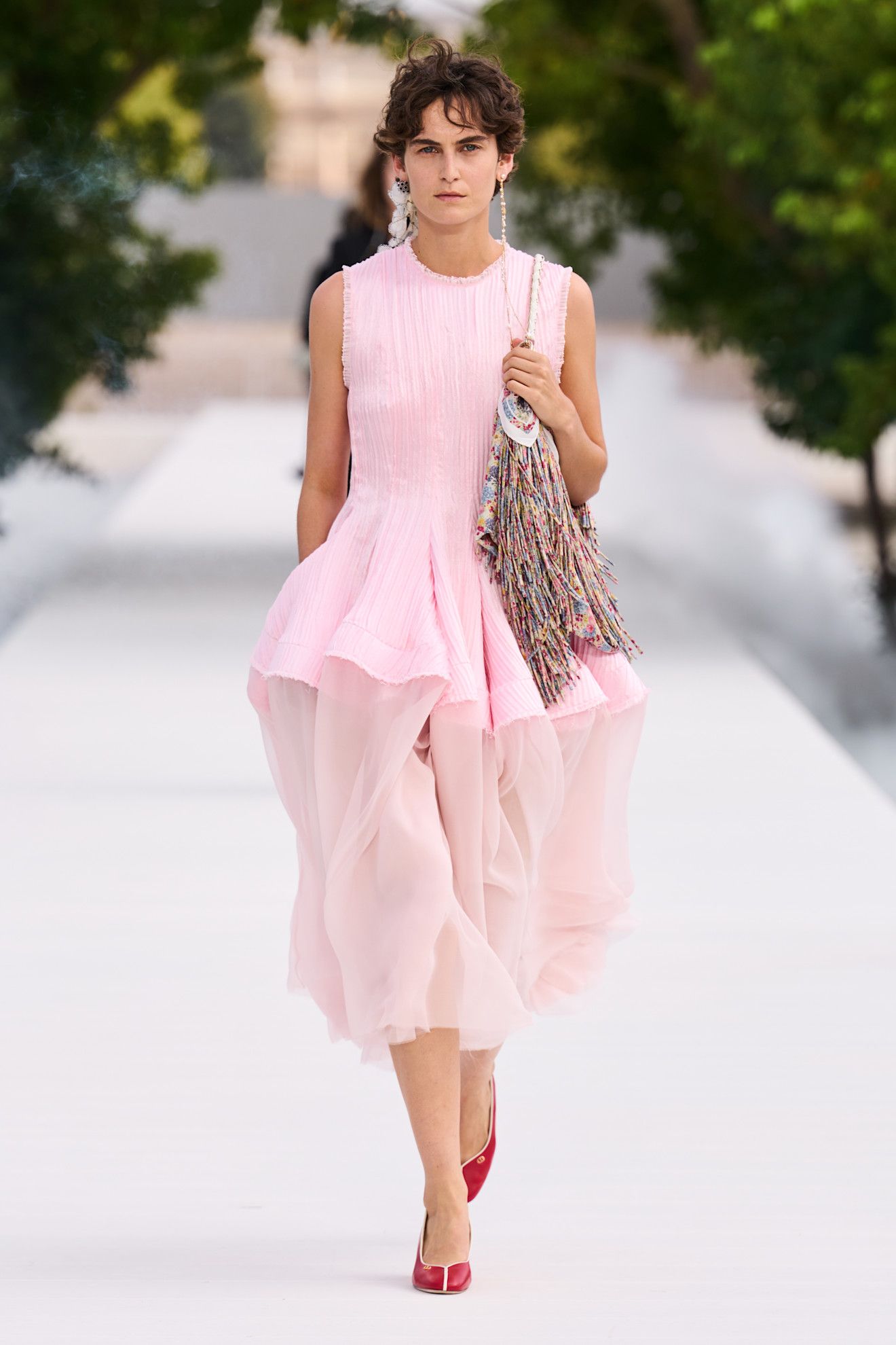 a woman wears a peplum dress at dior spring 2027.