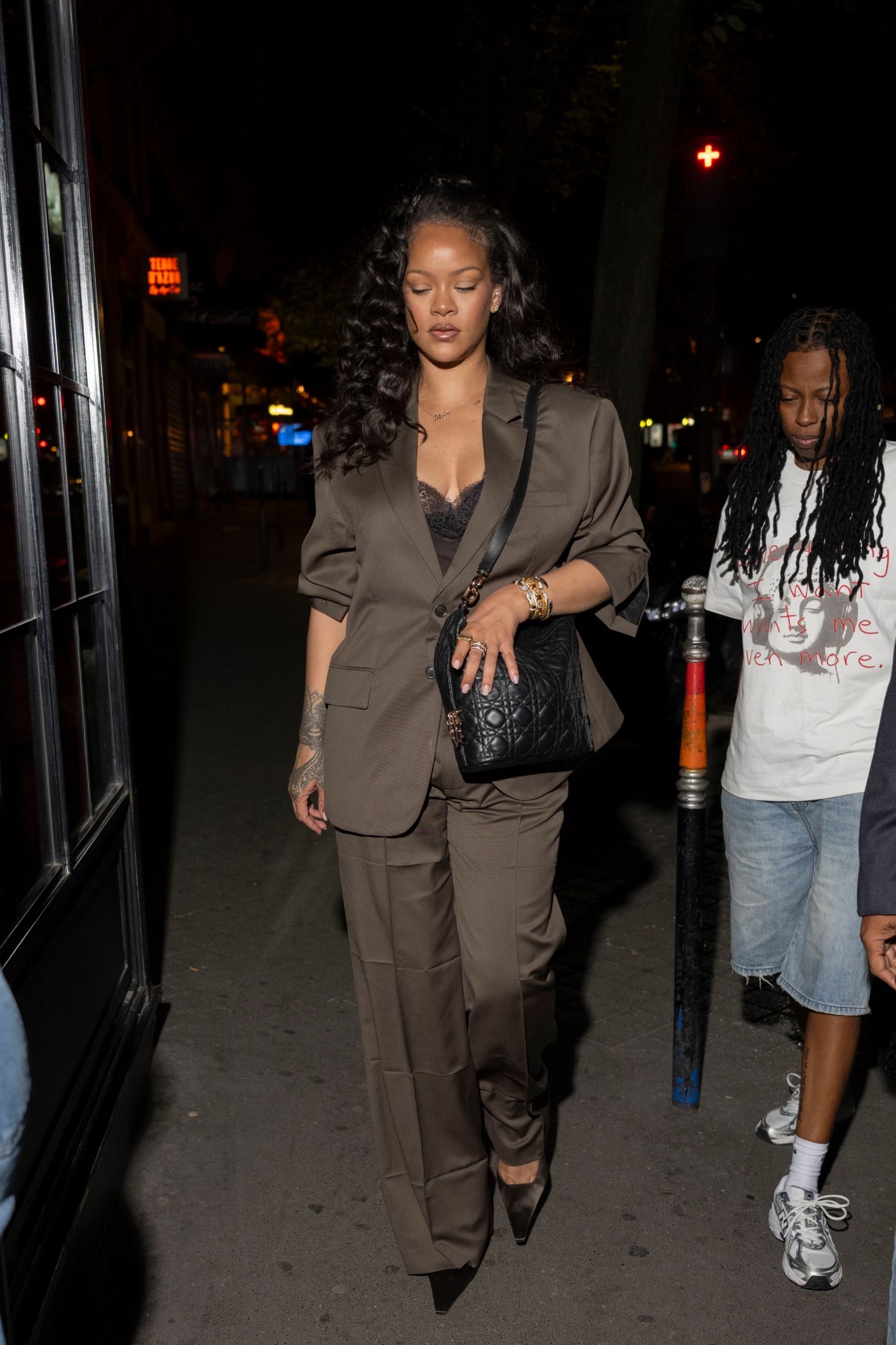 Rihanna in a brown suit