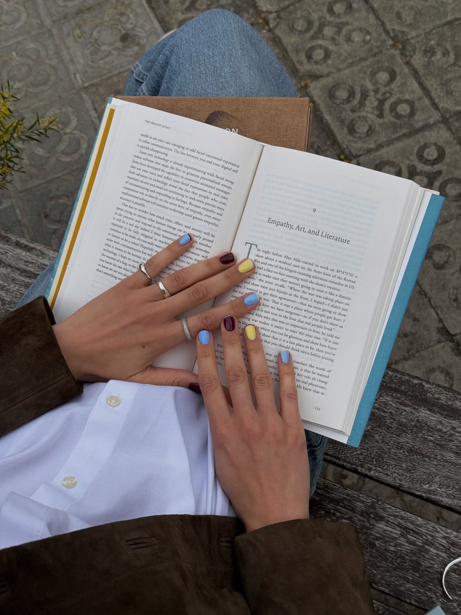 @matejanova wearing a yellow, blue and burgundy manicure with contrasting colours on each nail