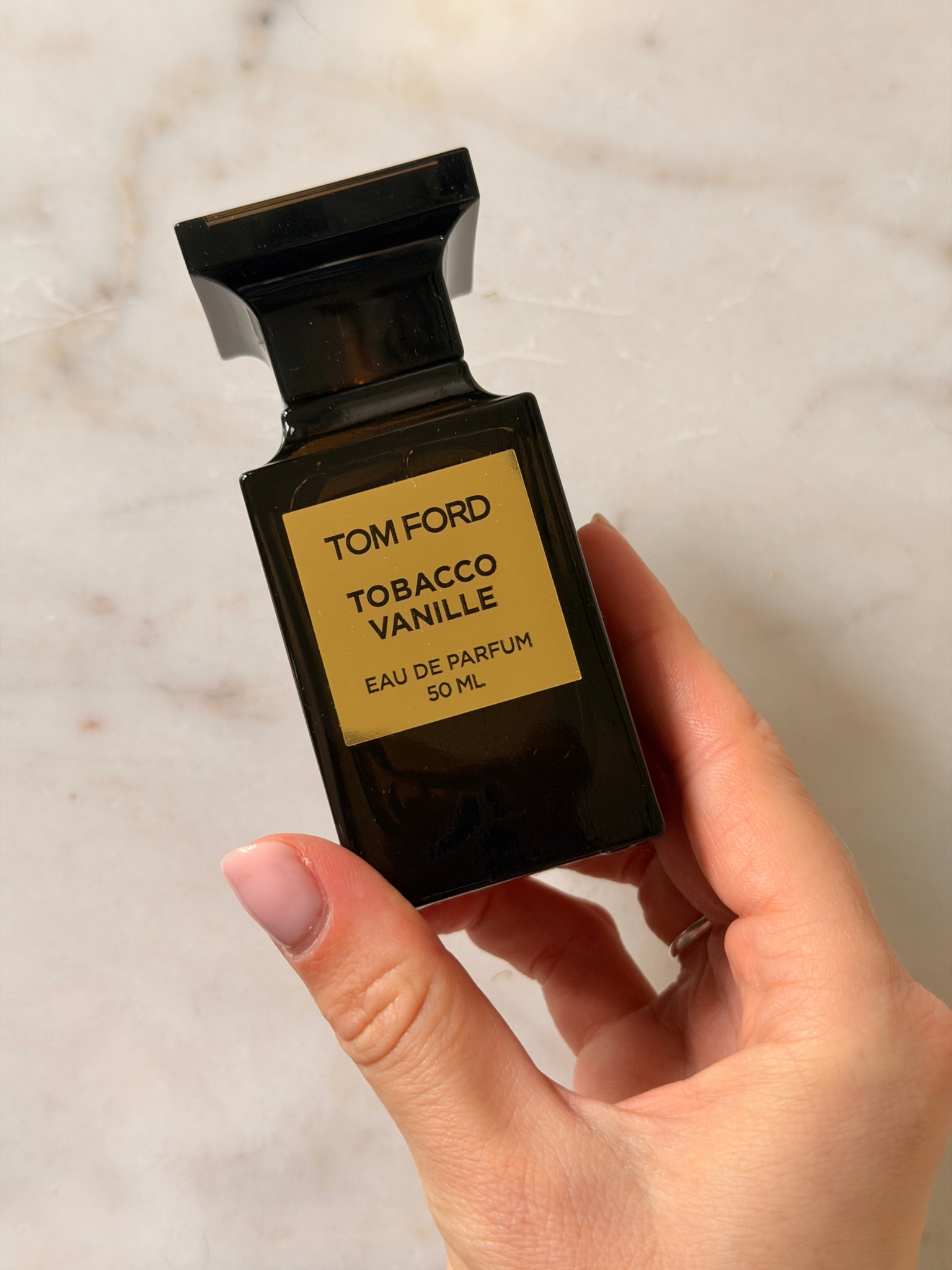 Freelance beauty editor Grace Day holding a bottle of Tom Ford Tobacco Vanille