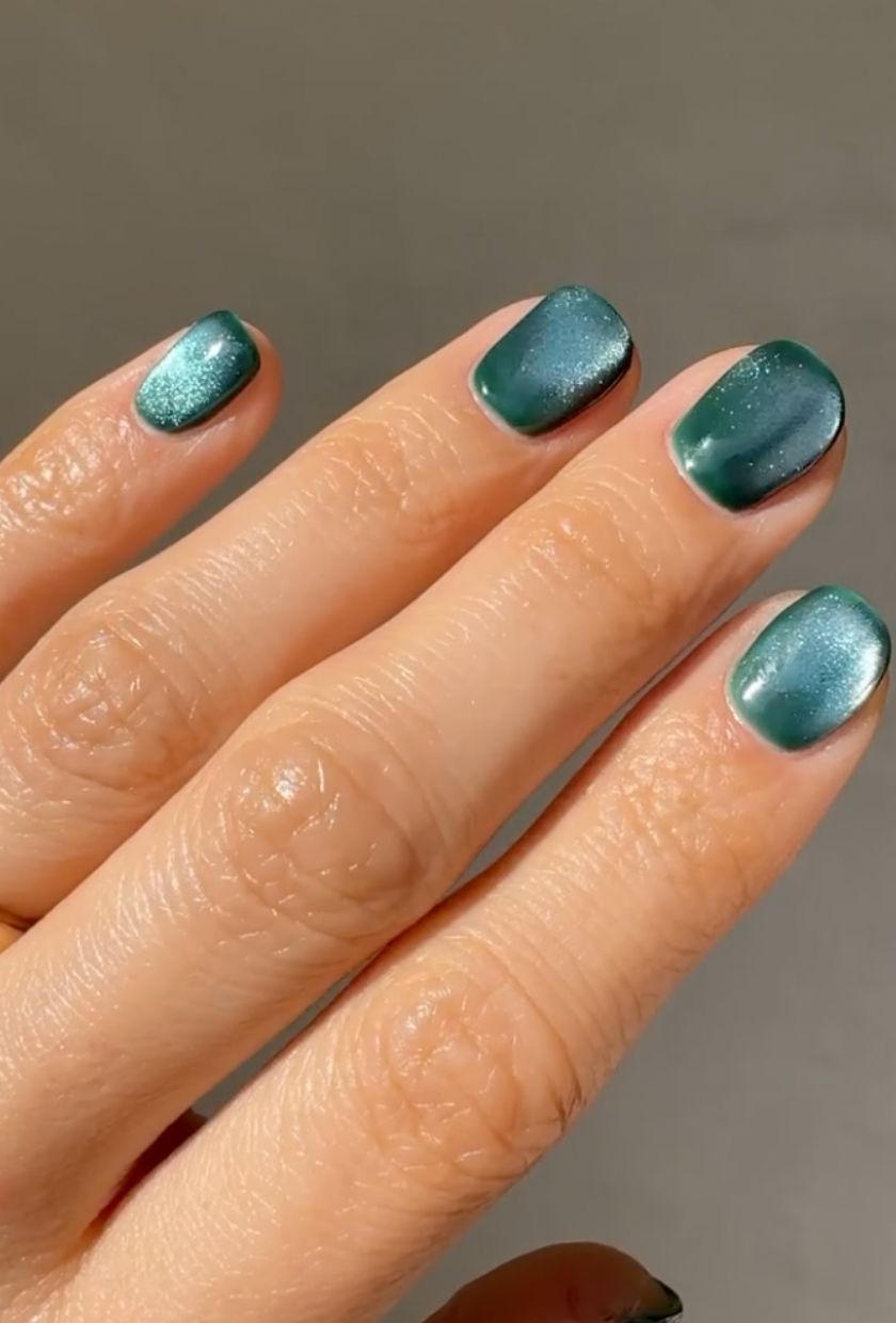 a close-up shot of turquoise velvet nails