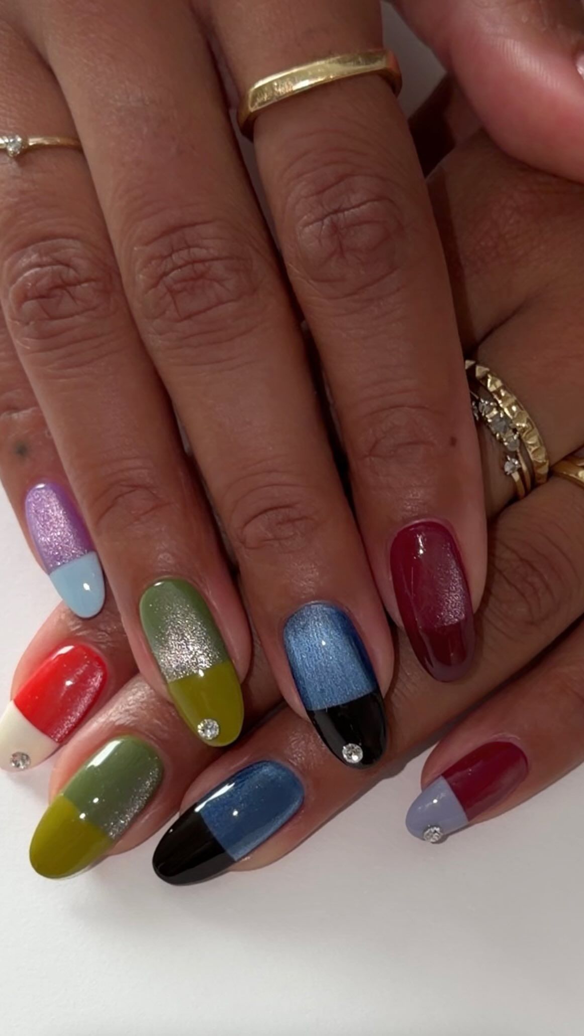 A cat eye manicure with contrasting colour blocking French tips