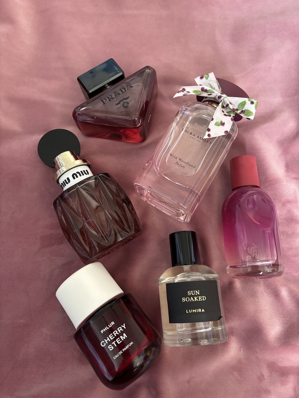 Mica Ricketts selection of forest fruit perfume bottles including Prada, Phlur, Miu Miu and Glossier