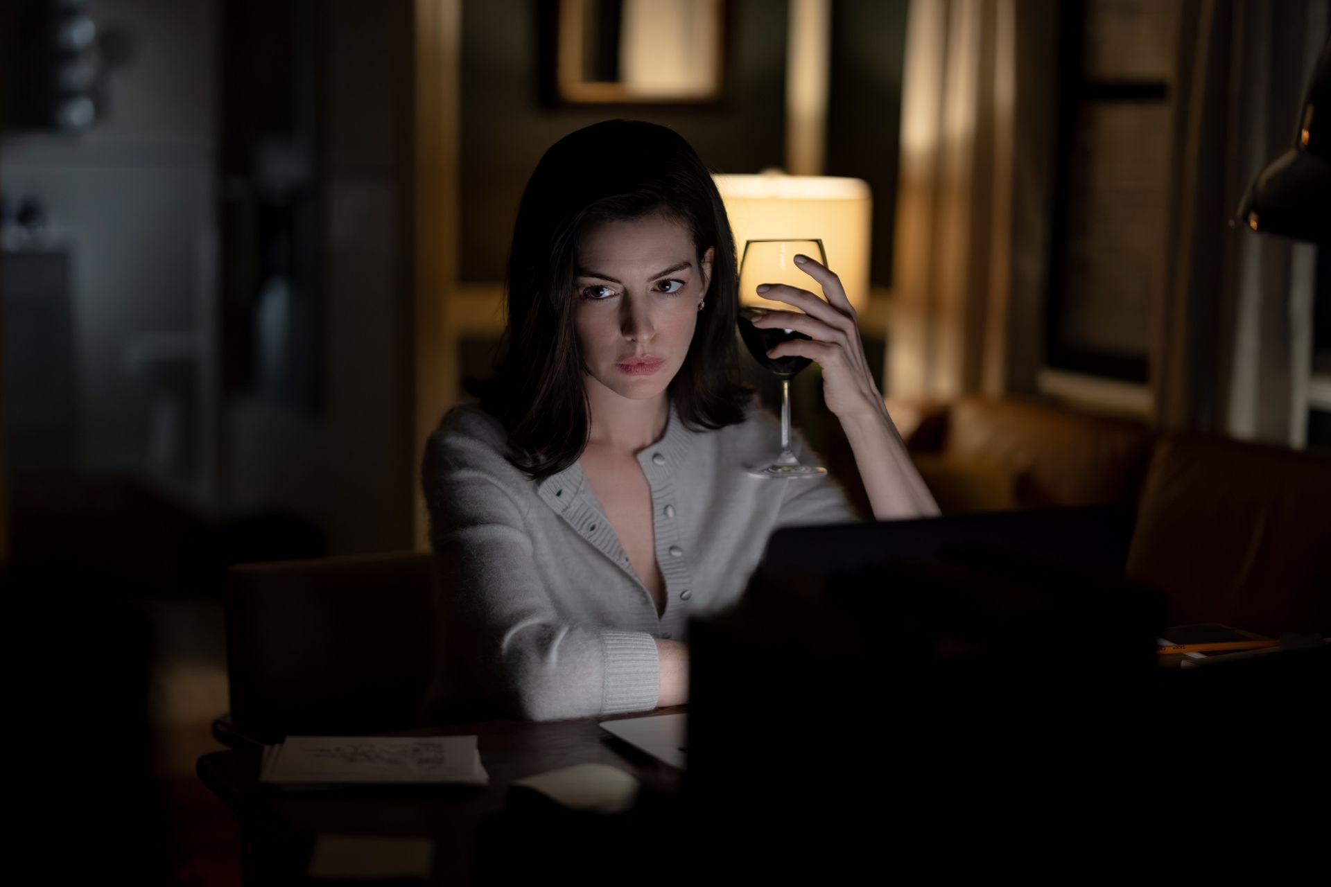 An image of Anne Hathaway wearing a grey cardigan in the 2026 movie Verity.