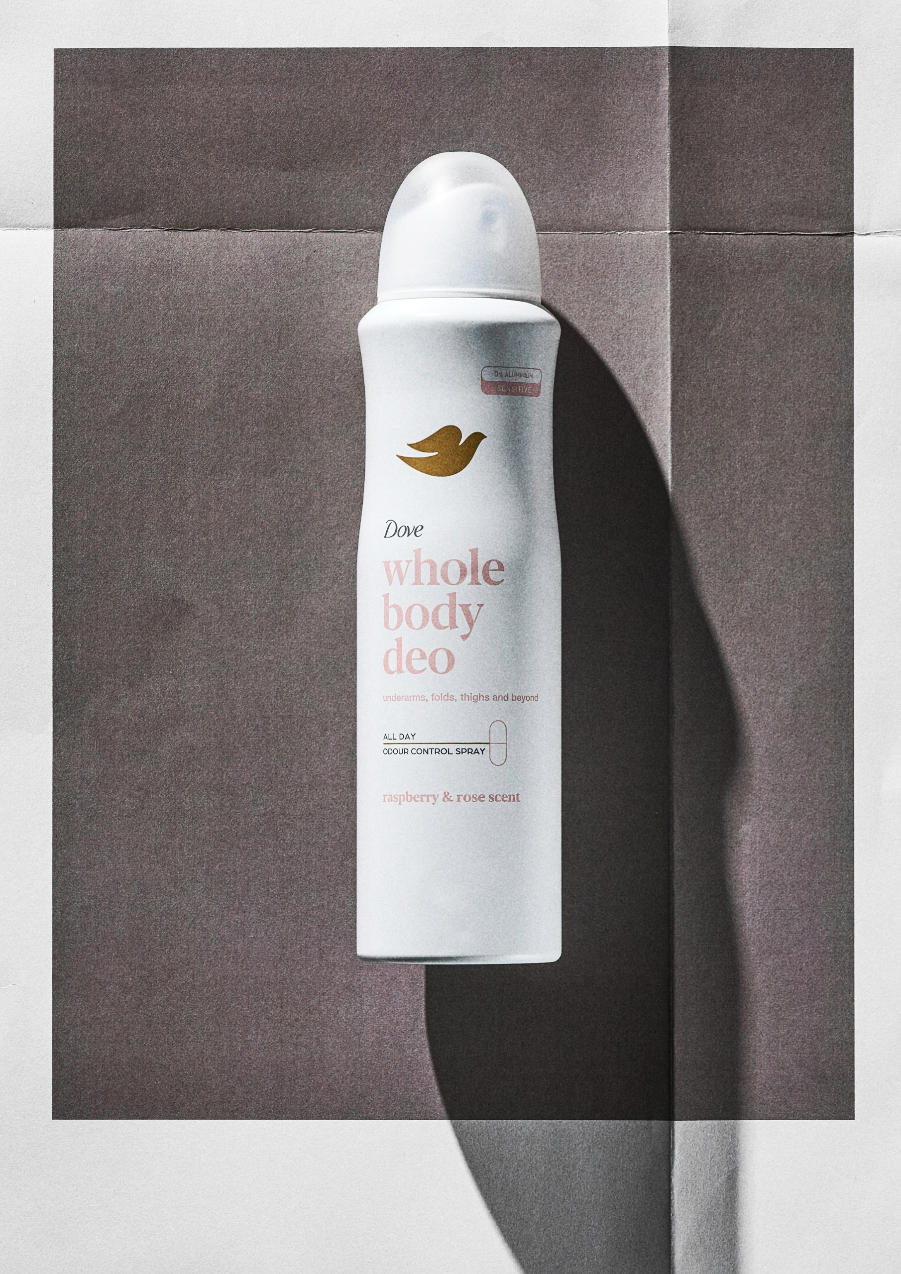 Dove Raspberry & Rose Whole Body Deodorant Spray on a grey background
