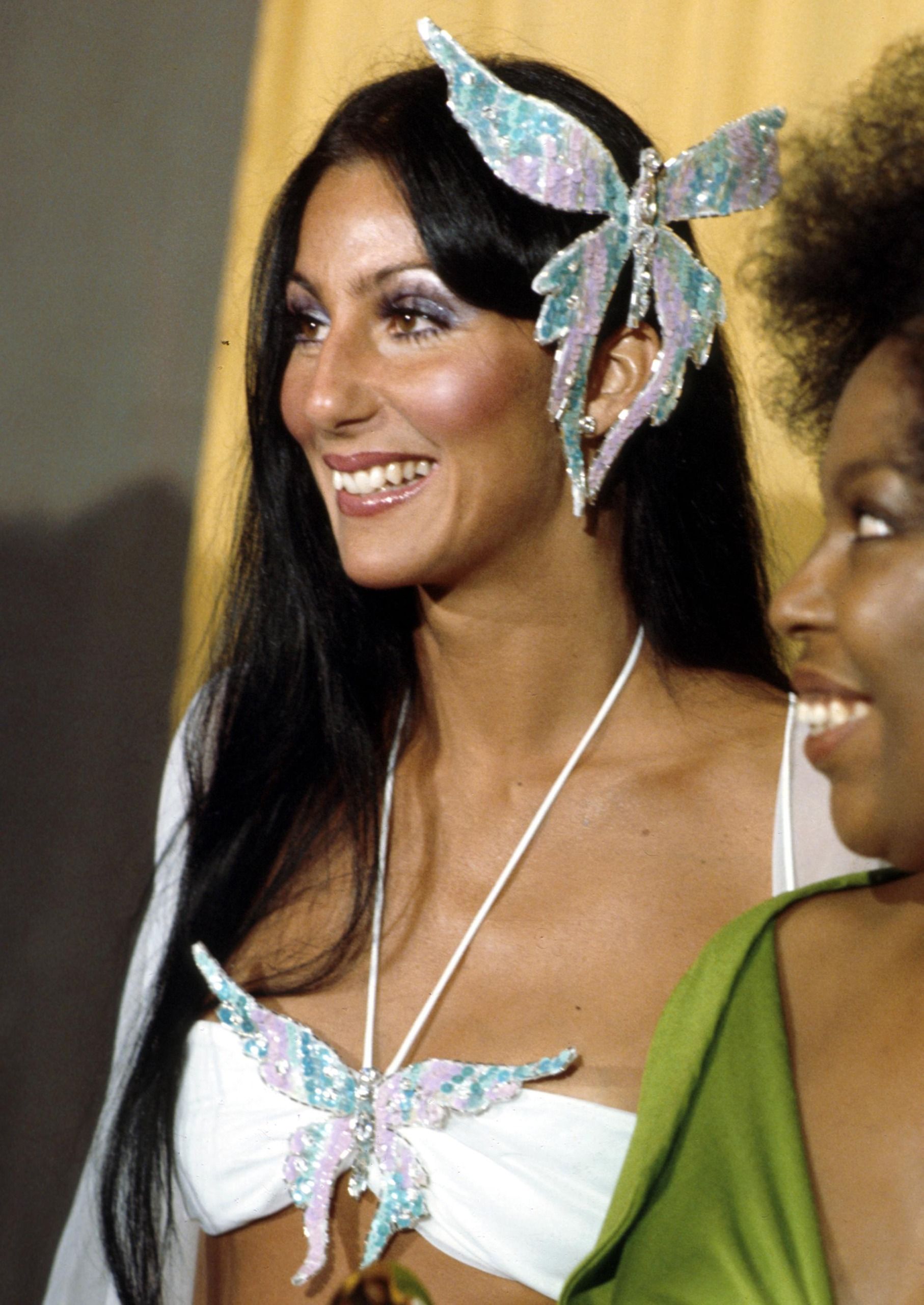 Cher attends the Grammy awards wearing a large butterfly pin in her hair on March 2, 1974 in Los Angeles, California.