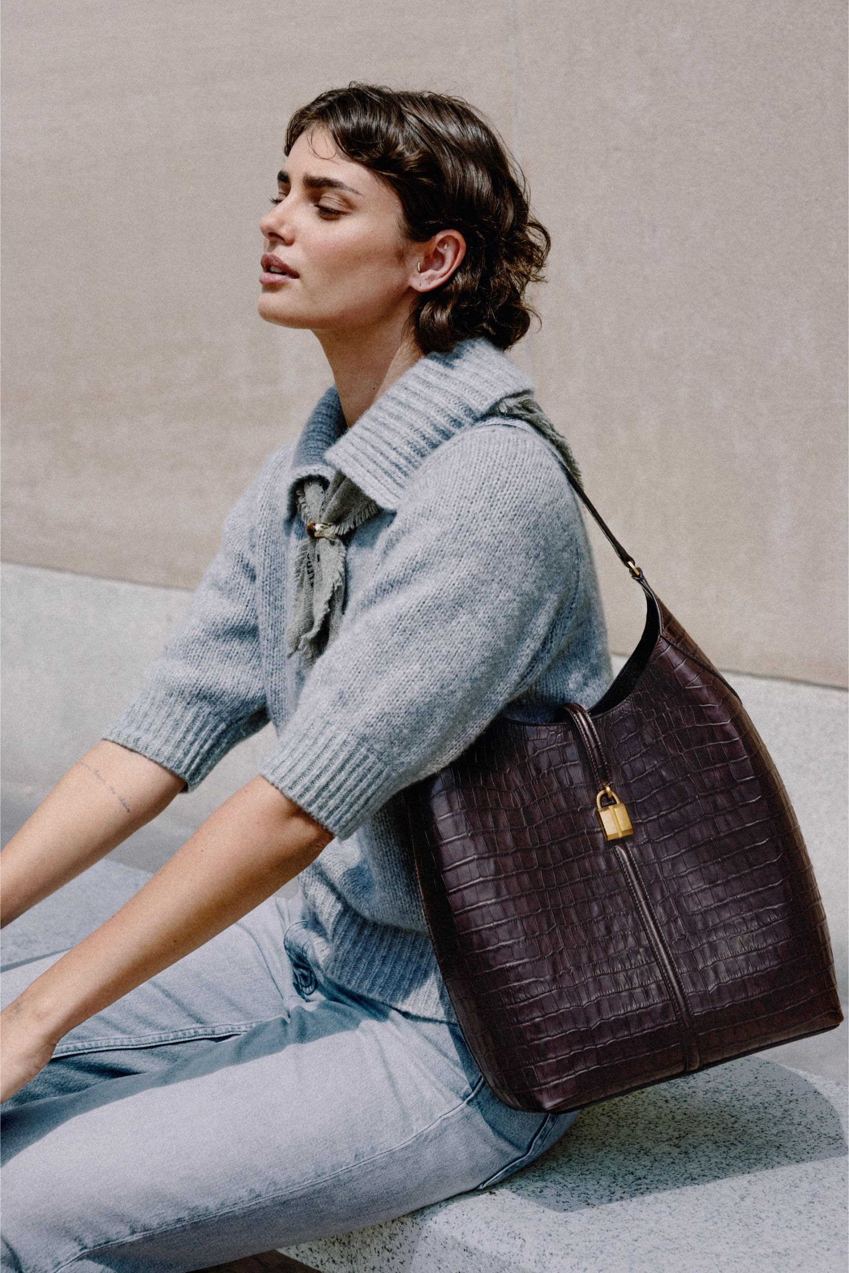 Taylor Hill carries the DeMellier Large Siena Bucket bag