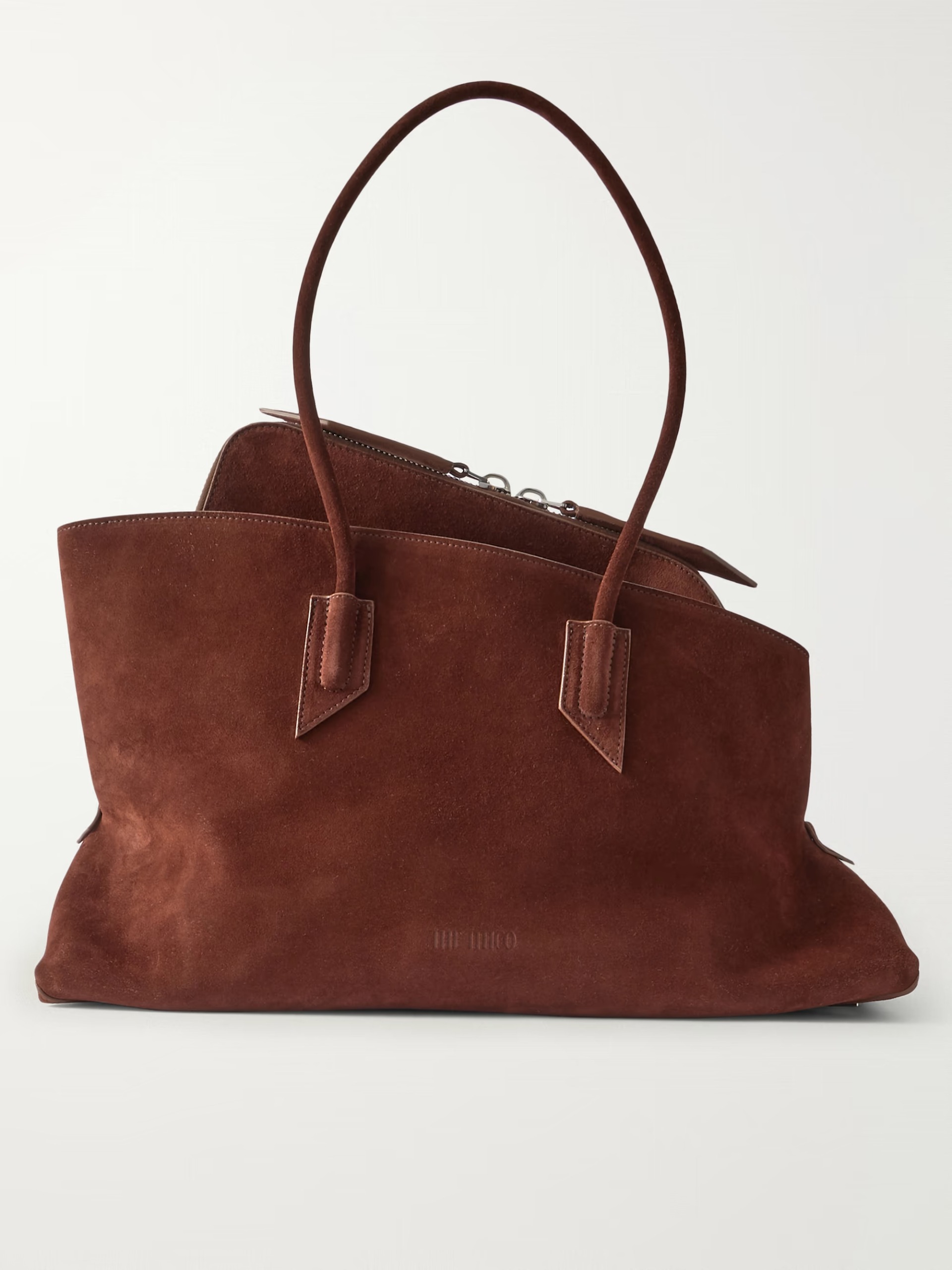 An image of an asymmetric tote from The Attico in a trapezoidal shape and made of brown suede