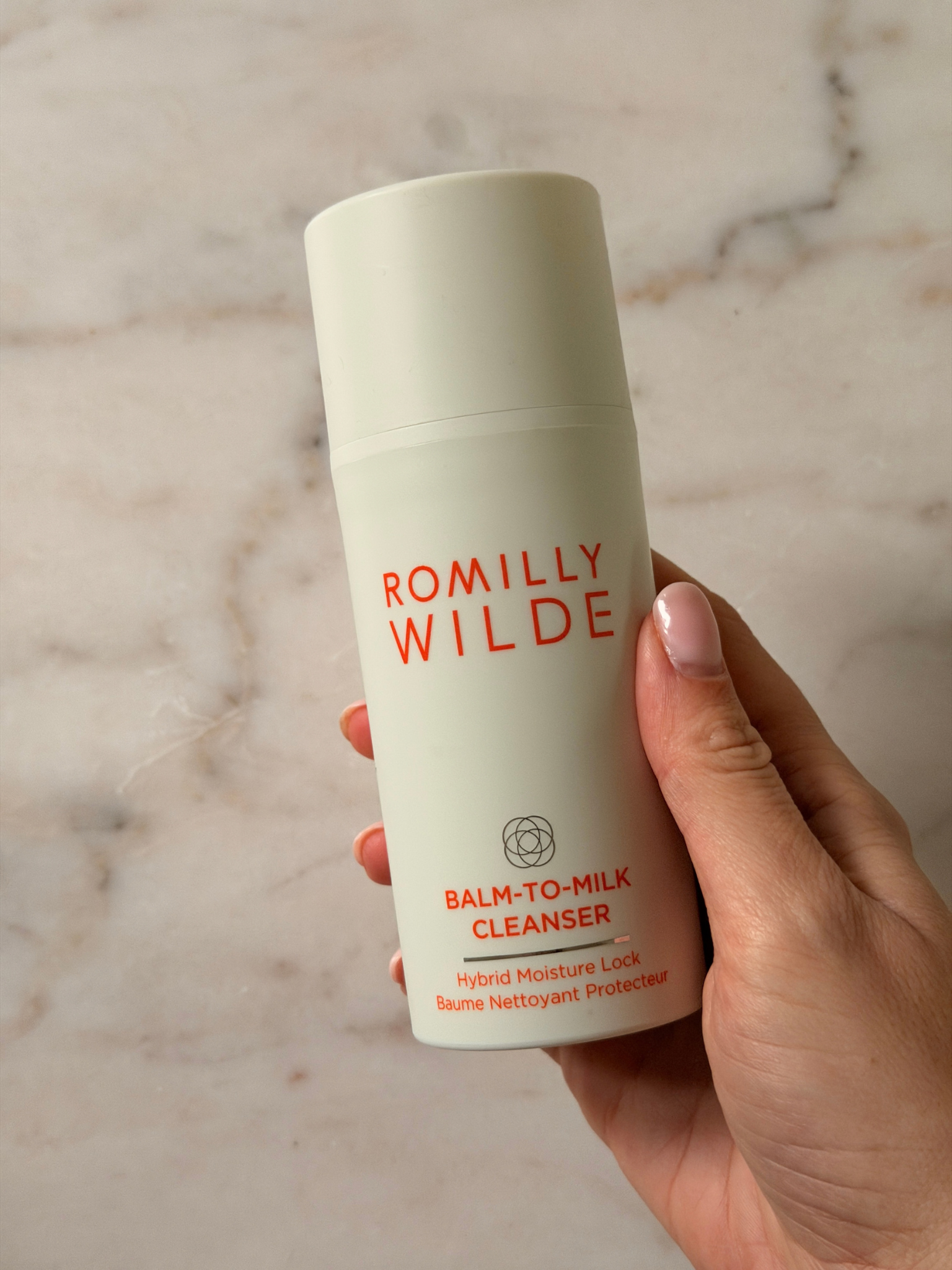 Freelance beauty editor Grace Day holding a bottle of