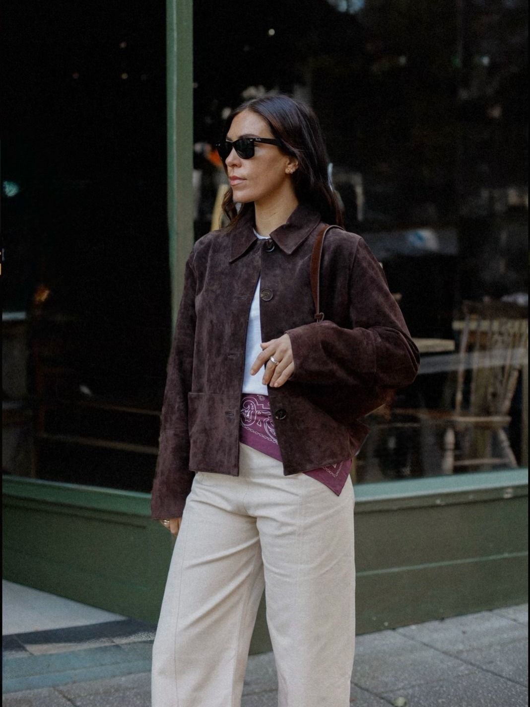 Woman wears brown suede jacket, white T-shirt, bandana and cotton trousers