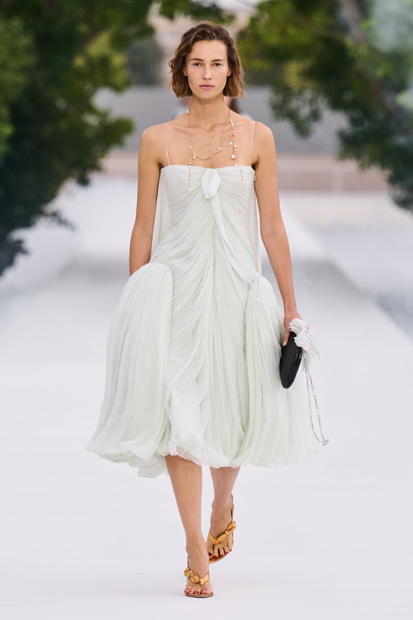 a woman wears a peplum dress at dior spring 2027.