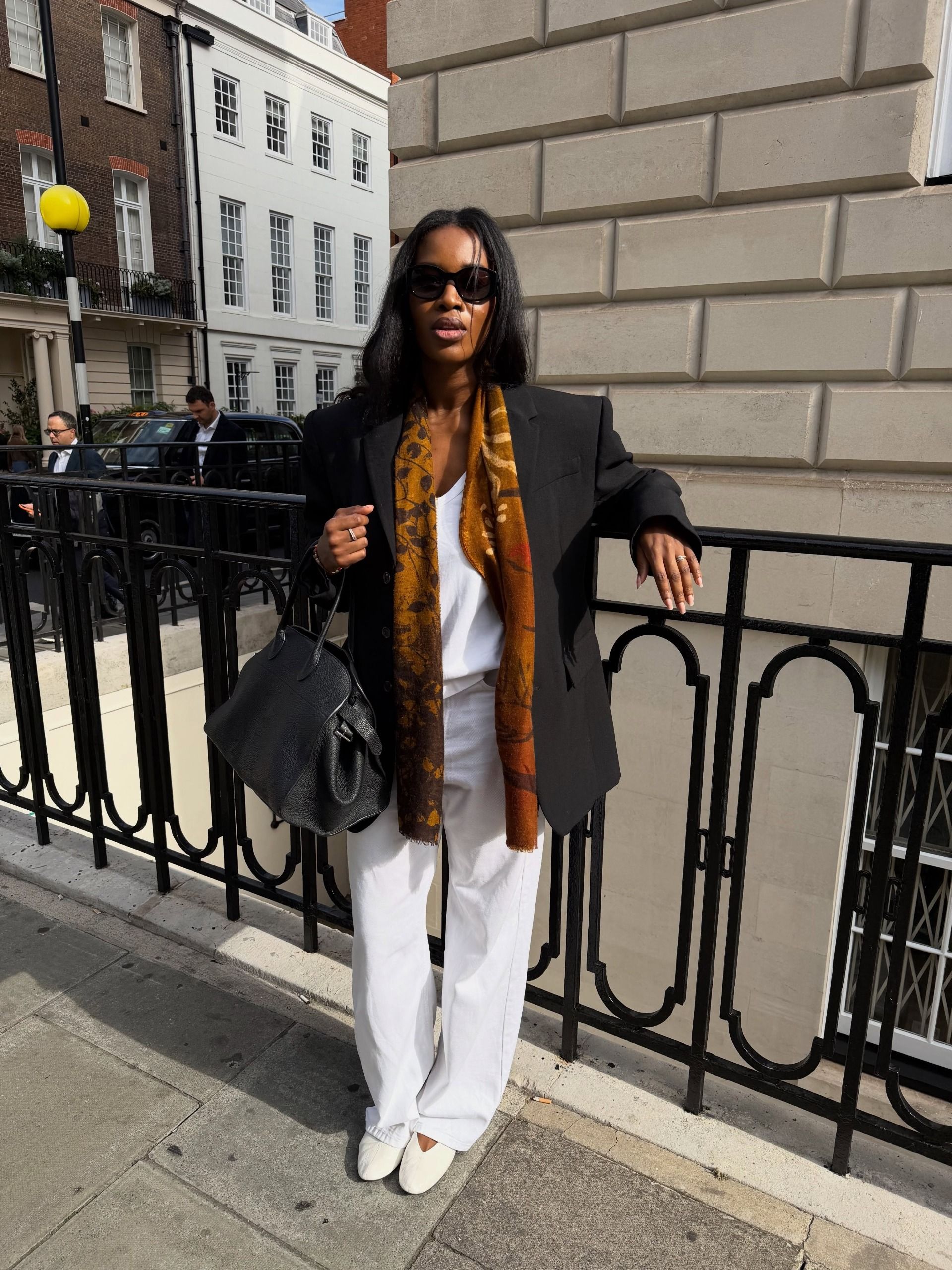 Woman wearing a fall 2026 outfit with white pants.