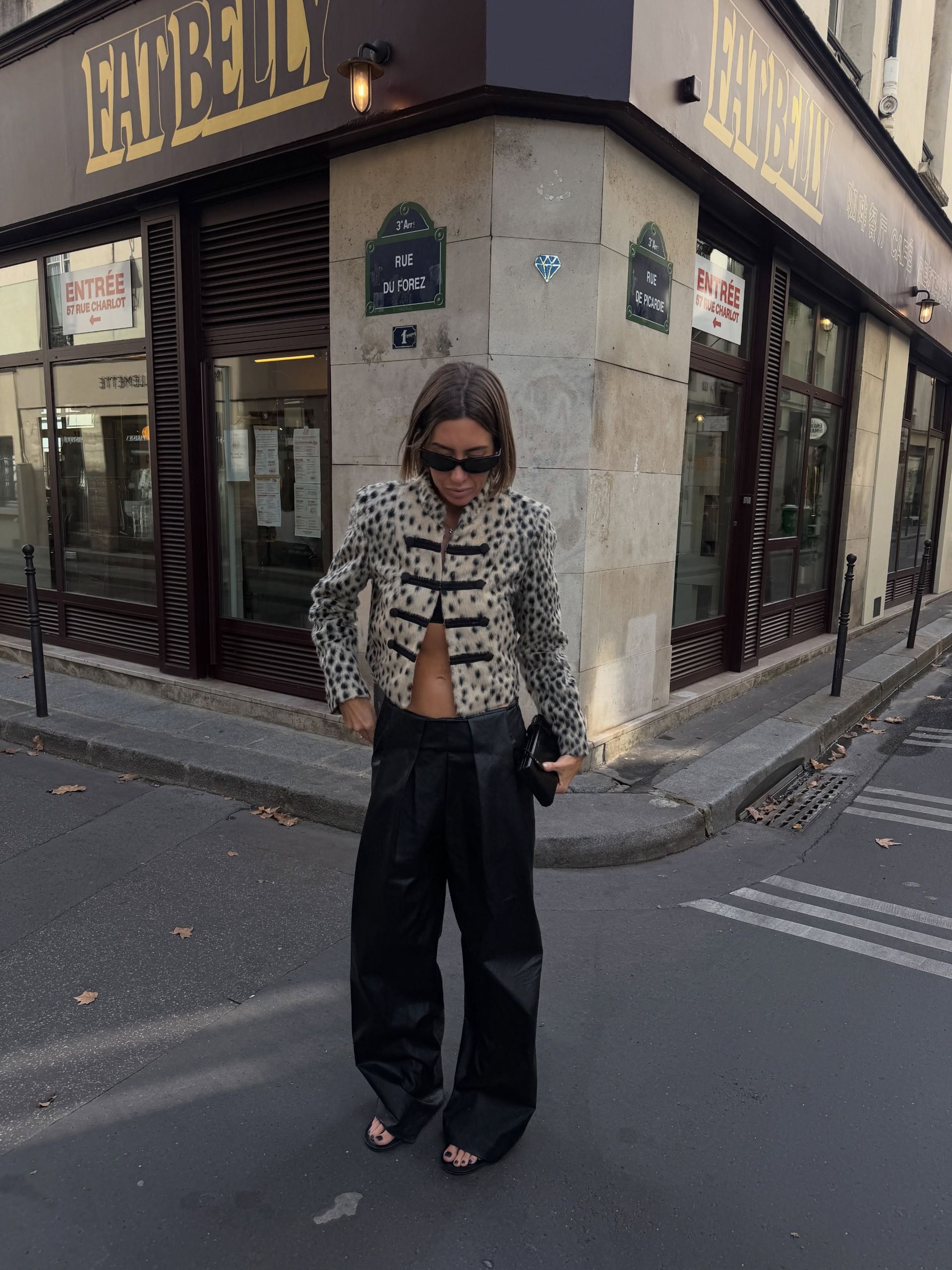 @hannahlewisstylist wears a leopard print jacket with contrasting black frog-tie fastenings with wide-leg trousers