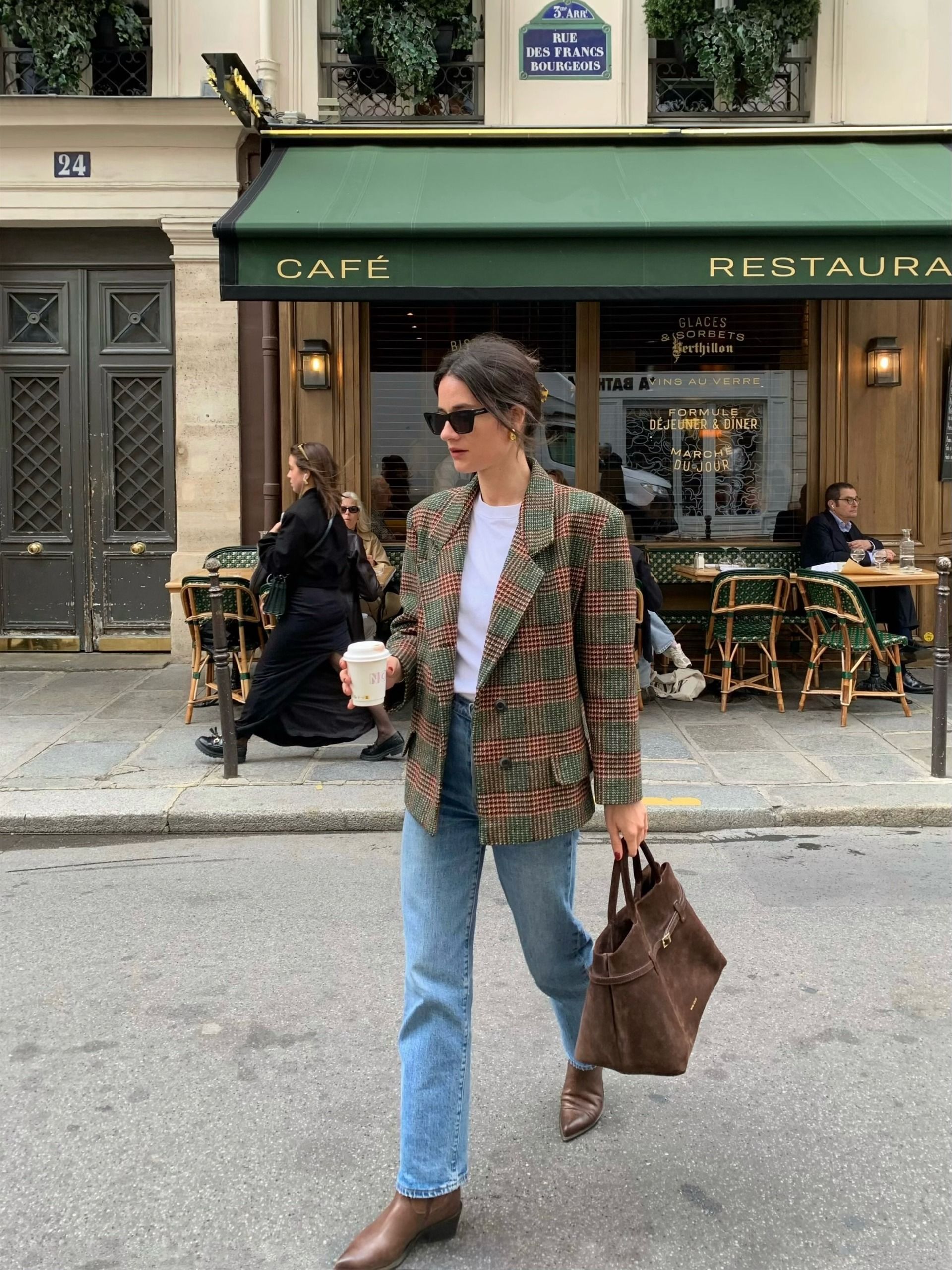 @leasy_inparis wears a green and orange wool checked blazer with blue jeans in the streets of Paris