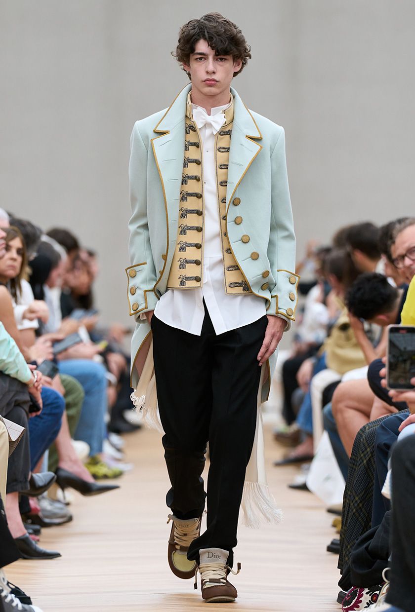 Dior menswear 2026 model wearing a military jacket with a shirt and trousers.