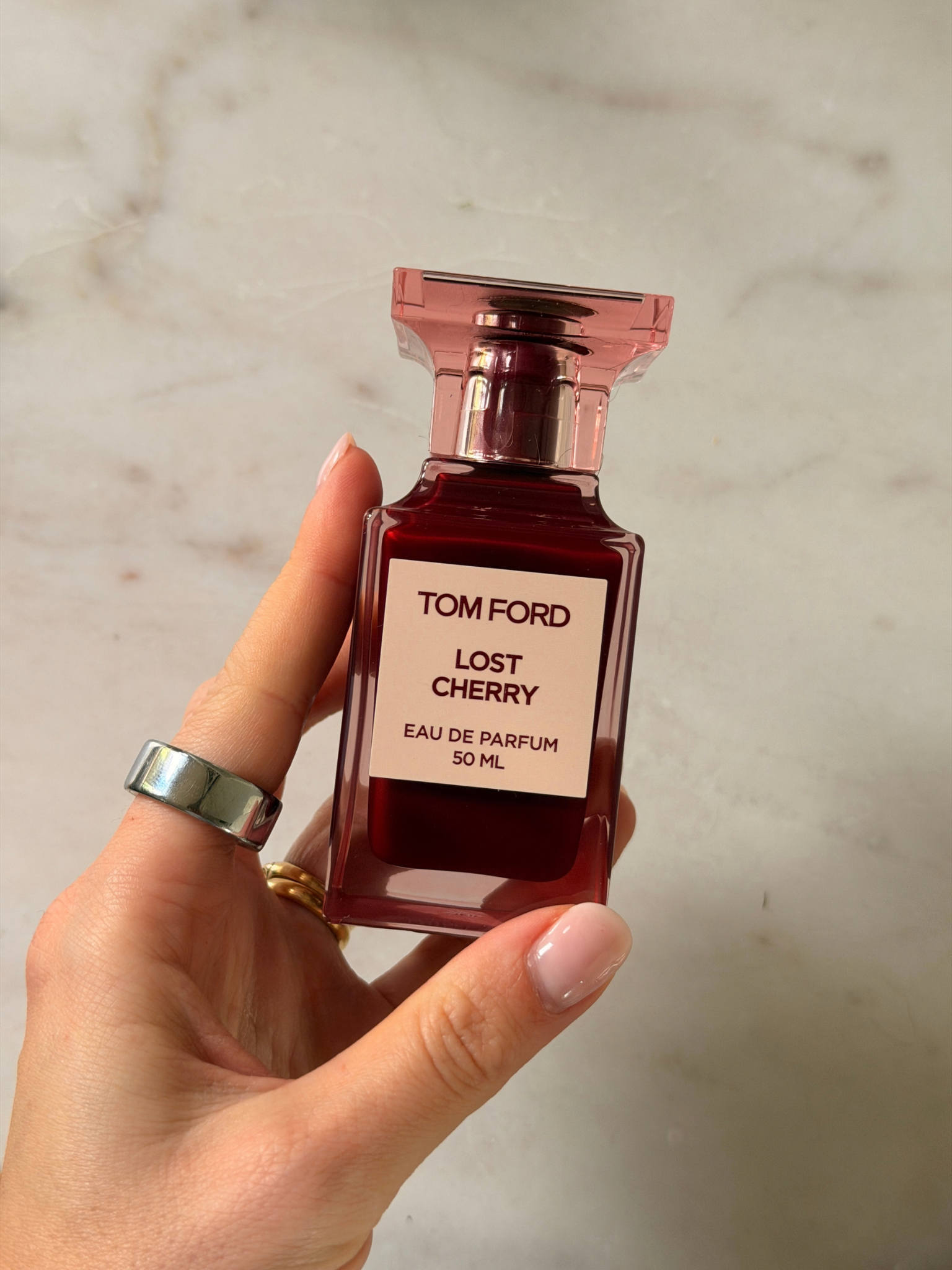 Freelance beauty editor Grace Day holding a bottle of Tom Ford Lost Cherry