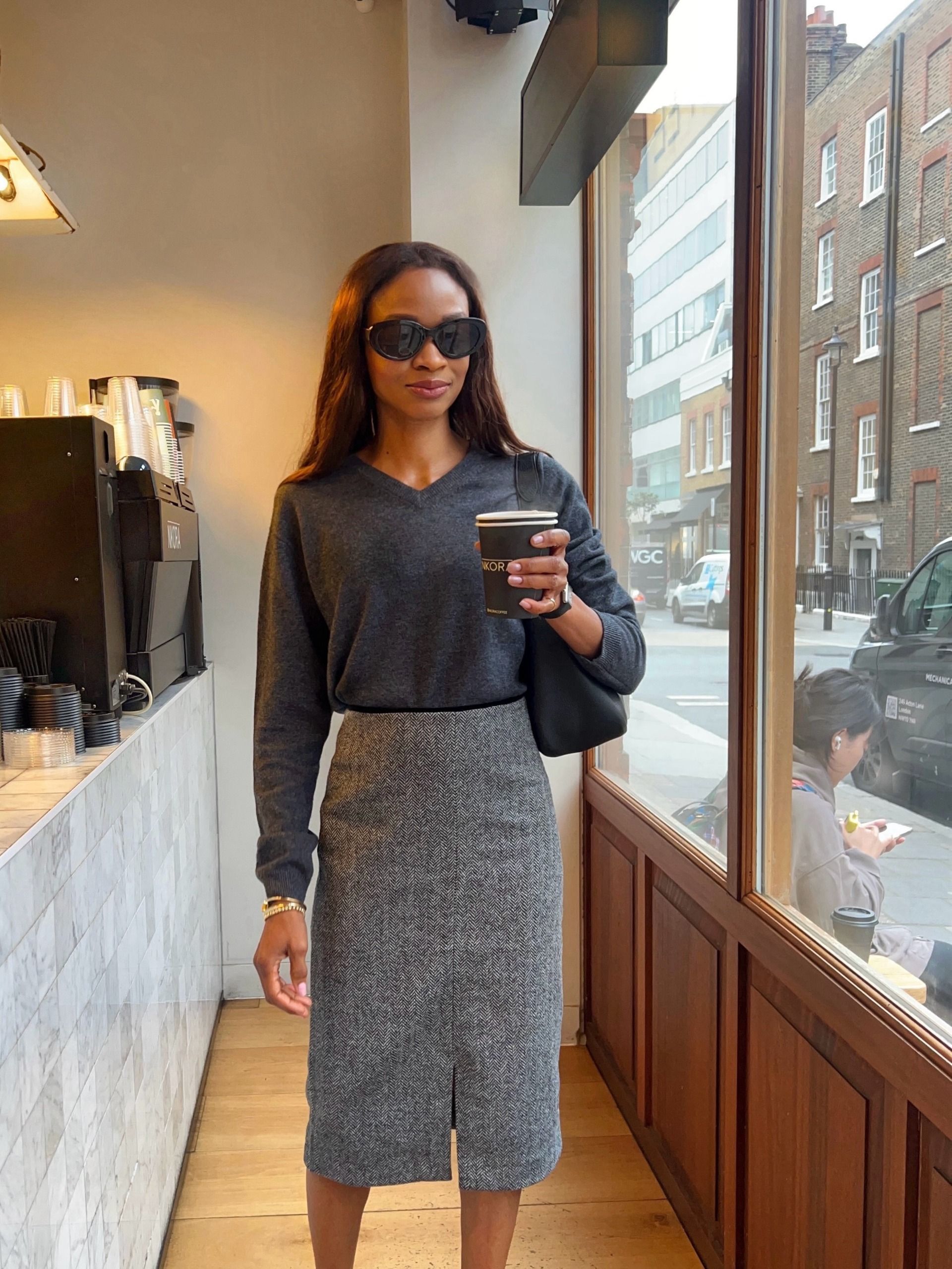 An image of a woman wearing skirt with slits outfit fall 2026