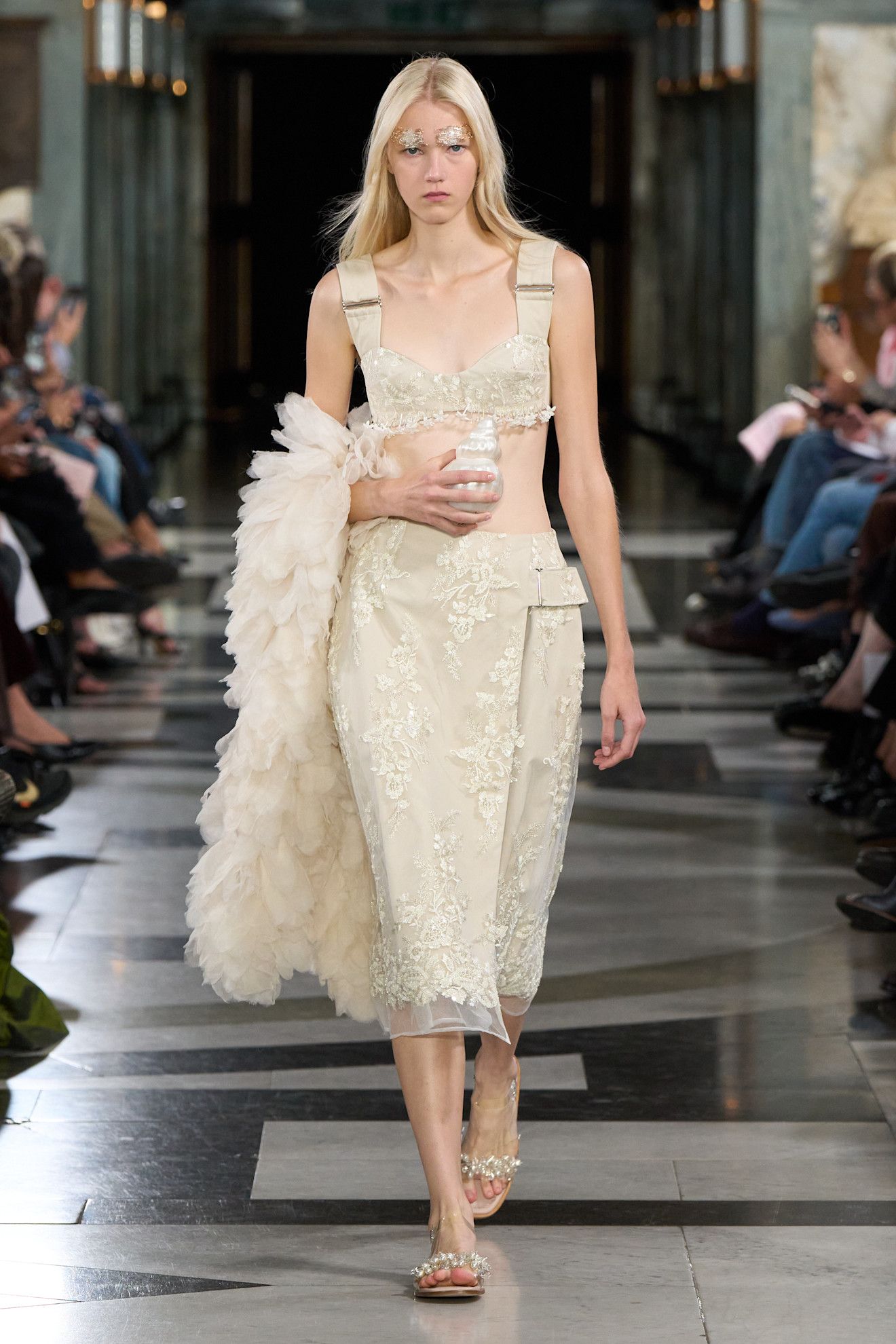 Spring/summer 2027 model wearing a bra top on the runway during fashion month.