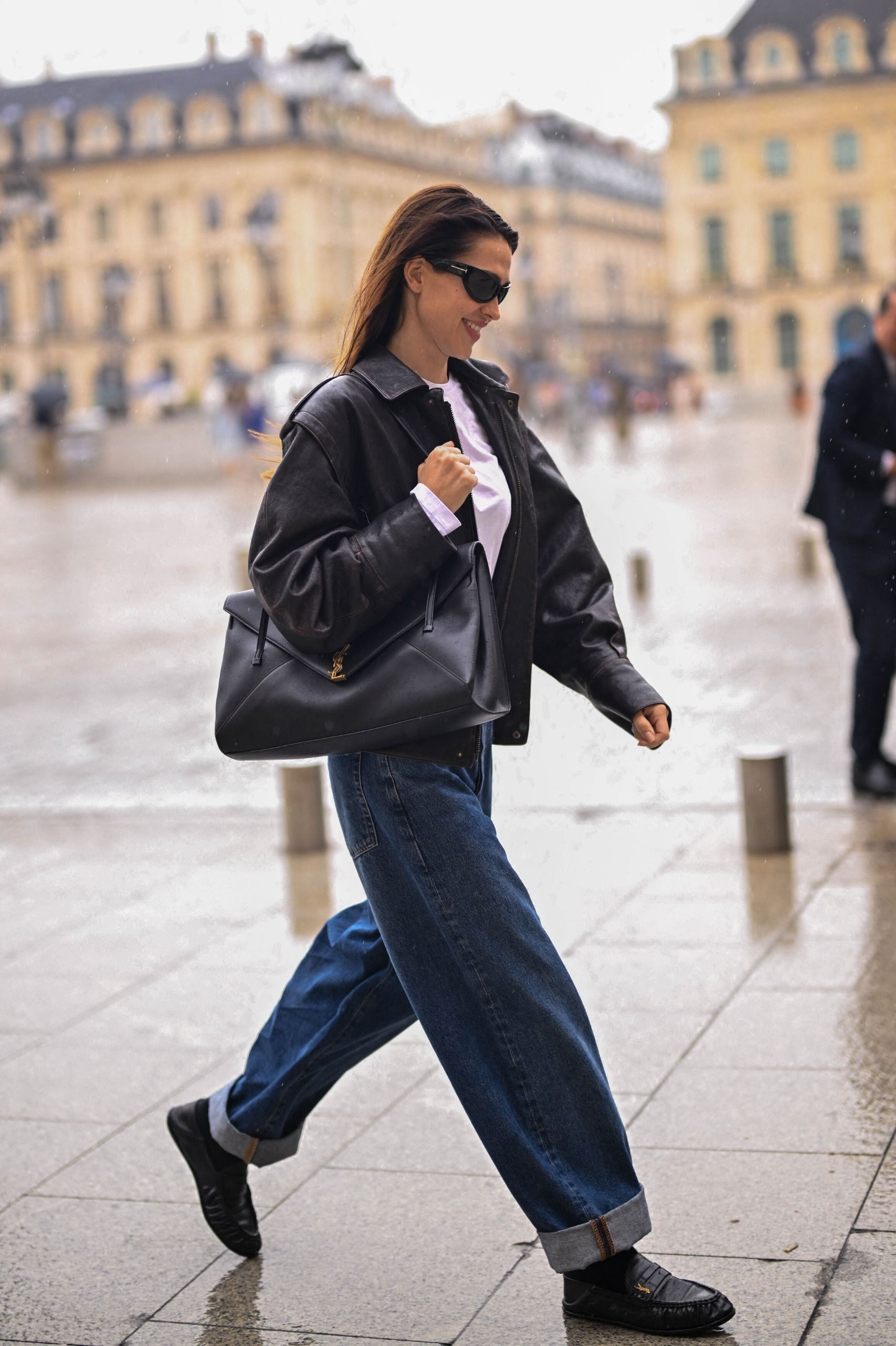 Amelia Gray wears a leather jacket, black turn-up jeans, black loafers and carries the Saint Laurent Simone Bag