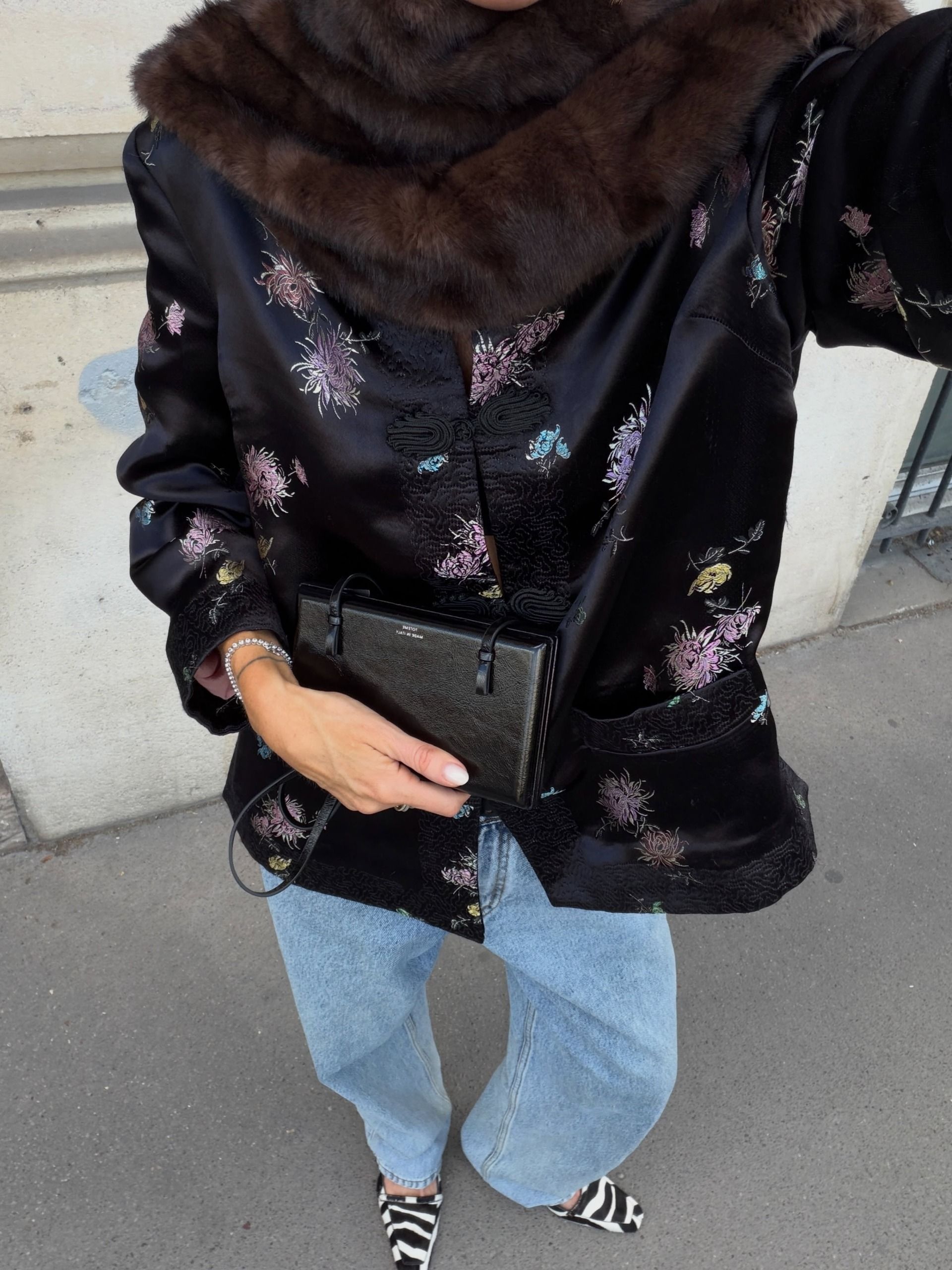 An image of @neridahtwist wearing a frog clasp jacket, one of the biggest It girl trends for winter 2026.