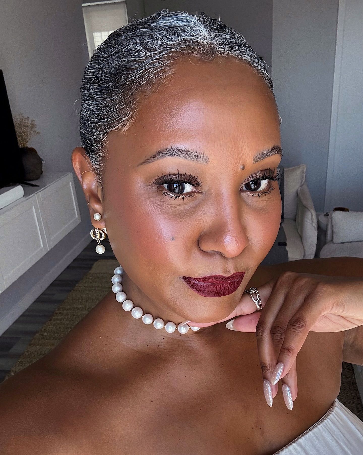 Tennille Jenkins with red lipstick on and her hair in a bun.