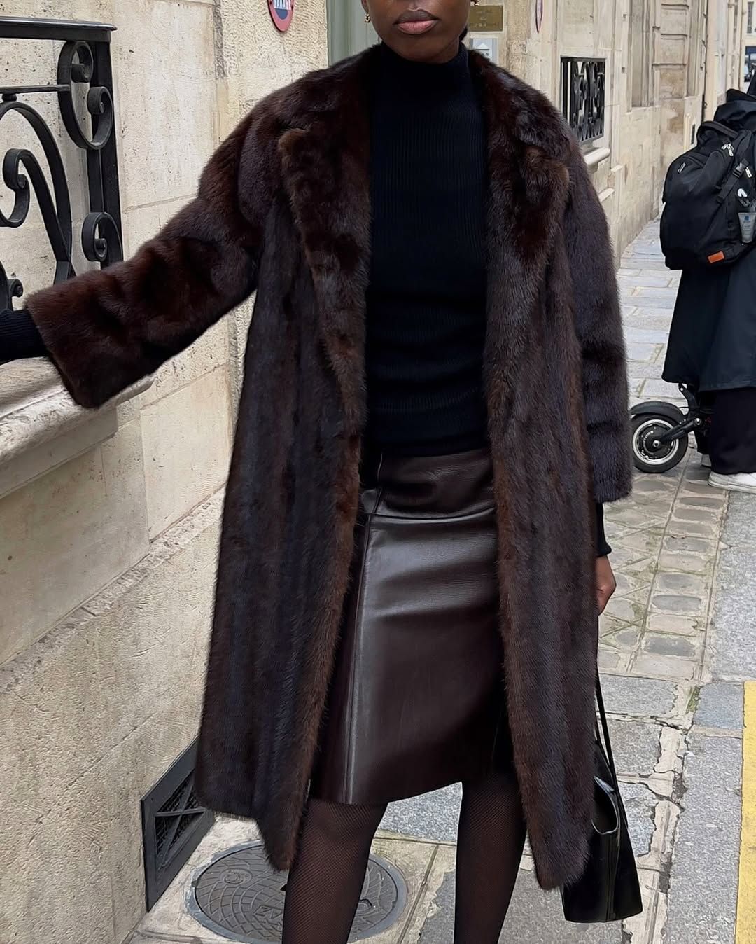 @sylviemus_ wears a brown faux fur coat and a brown leather pencil skirt with a black jumper
