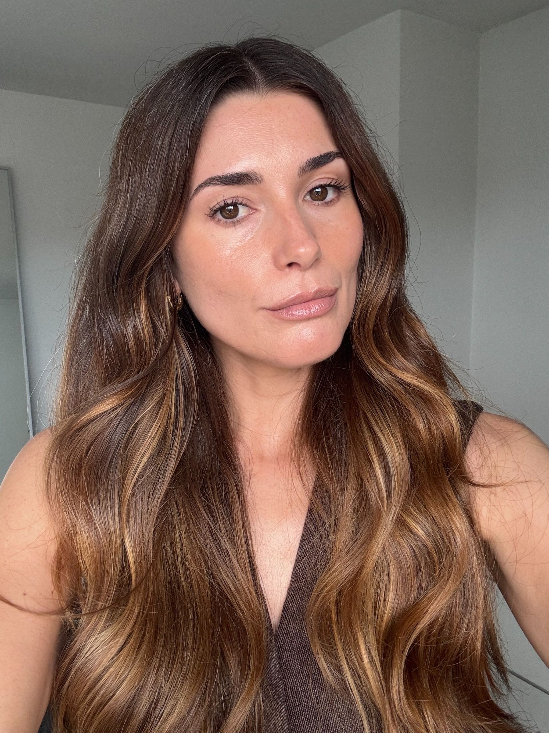 A photo of Who What Wear Beauty Editor Eleanor Vousden, with brunette hair and balayage