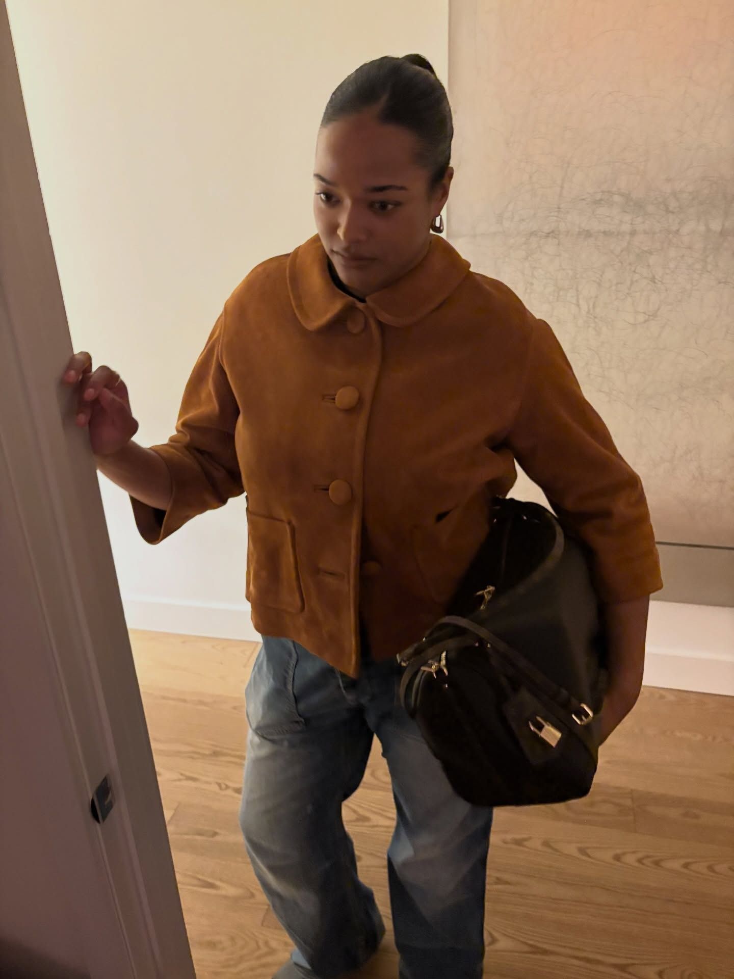 Woman showing how to wear a clutch this fall.