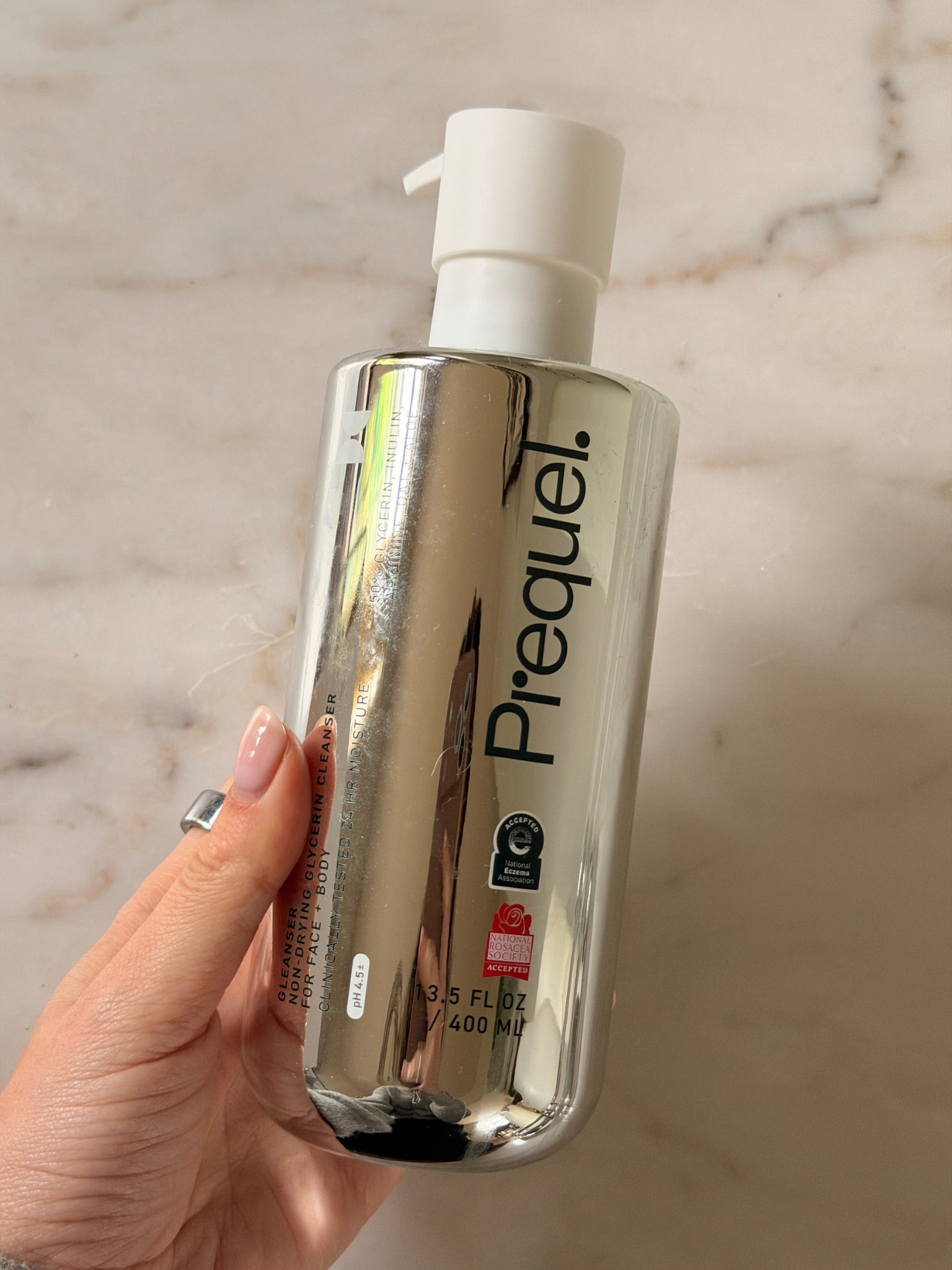 Freelance beauty editor Grace Day holding a bottle of prequel cleanser