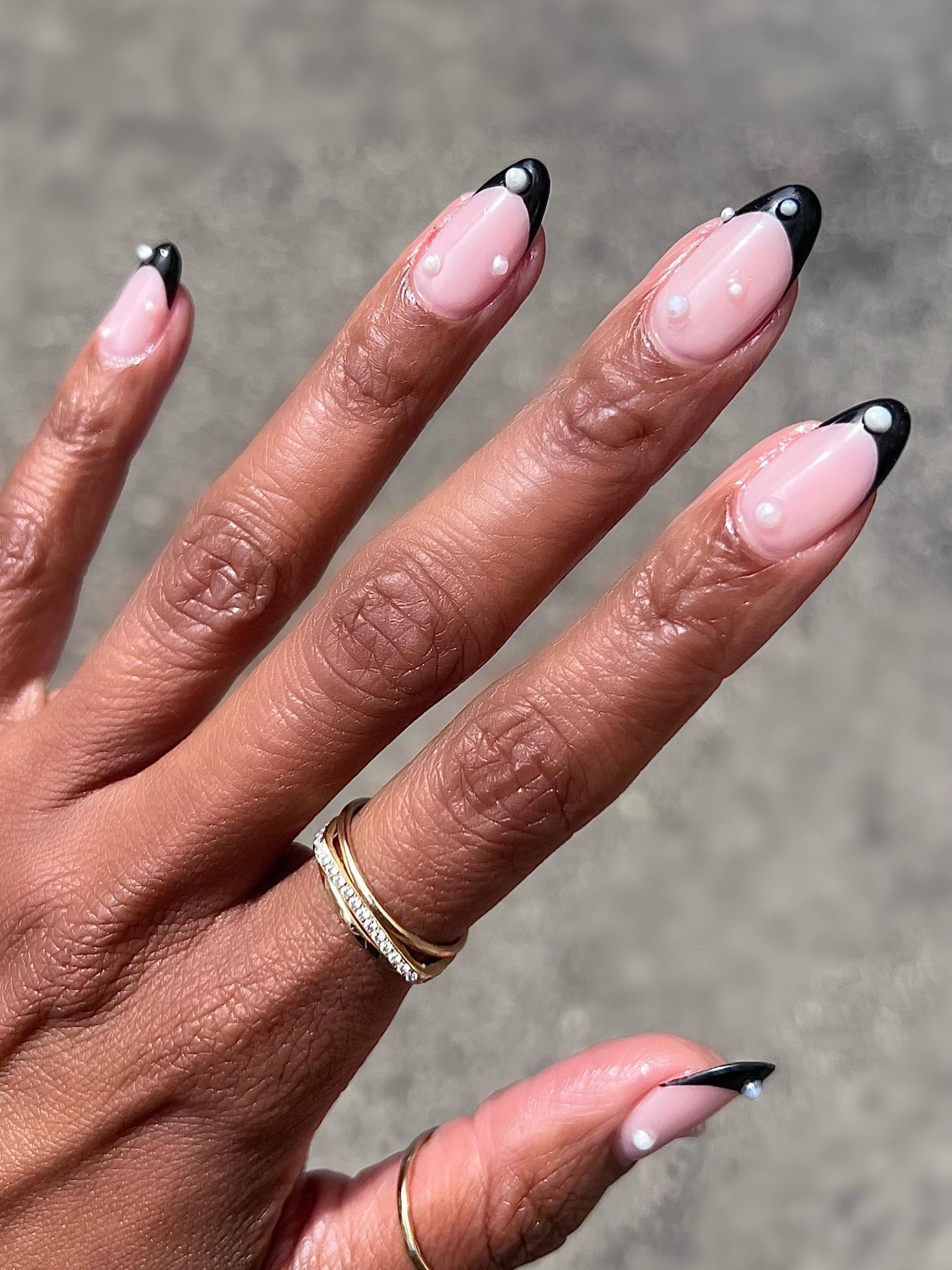 black french manicure with pearl detailing and pink base